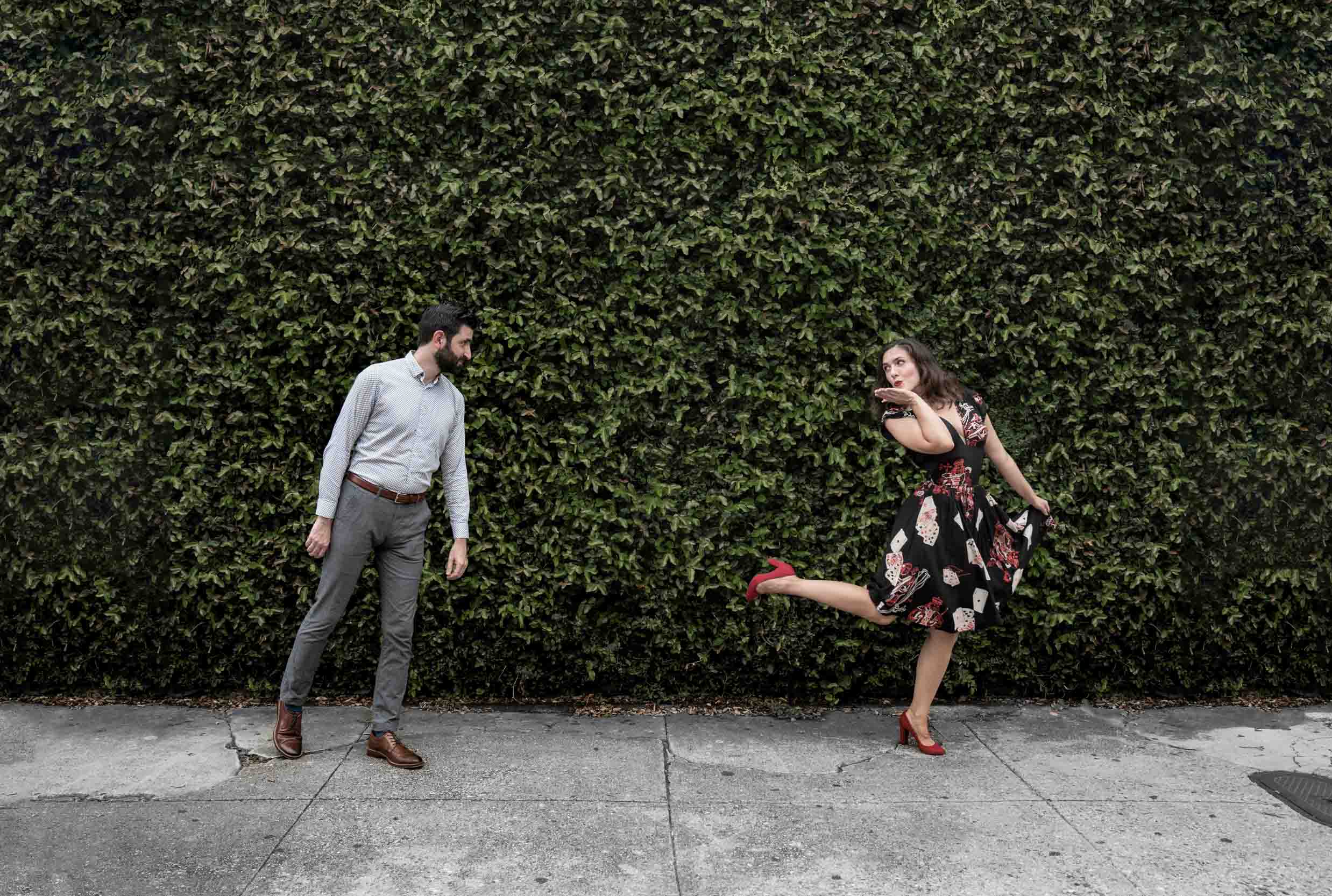 Romantic couple dancing together in the New Orleans French Quarter in front of ivory wall