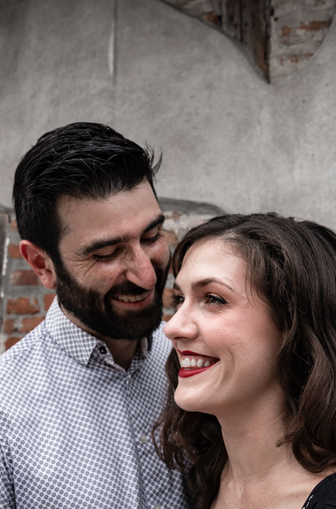 Romantic couple laughing together in front of rustic house in the New Orleans French Quarter