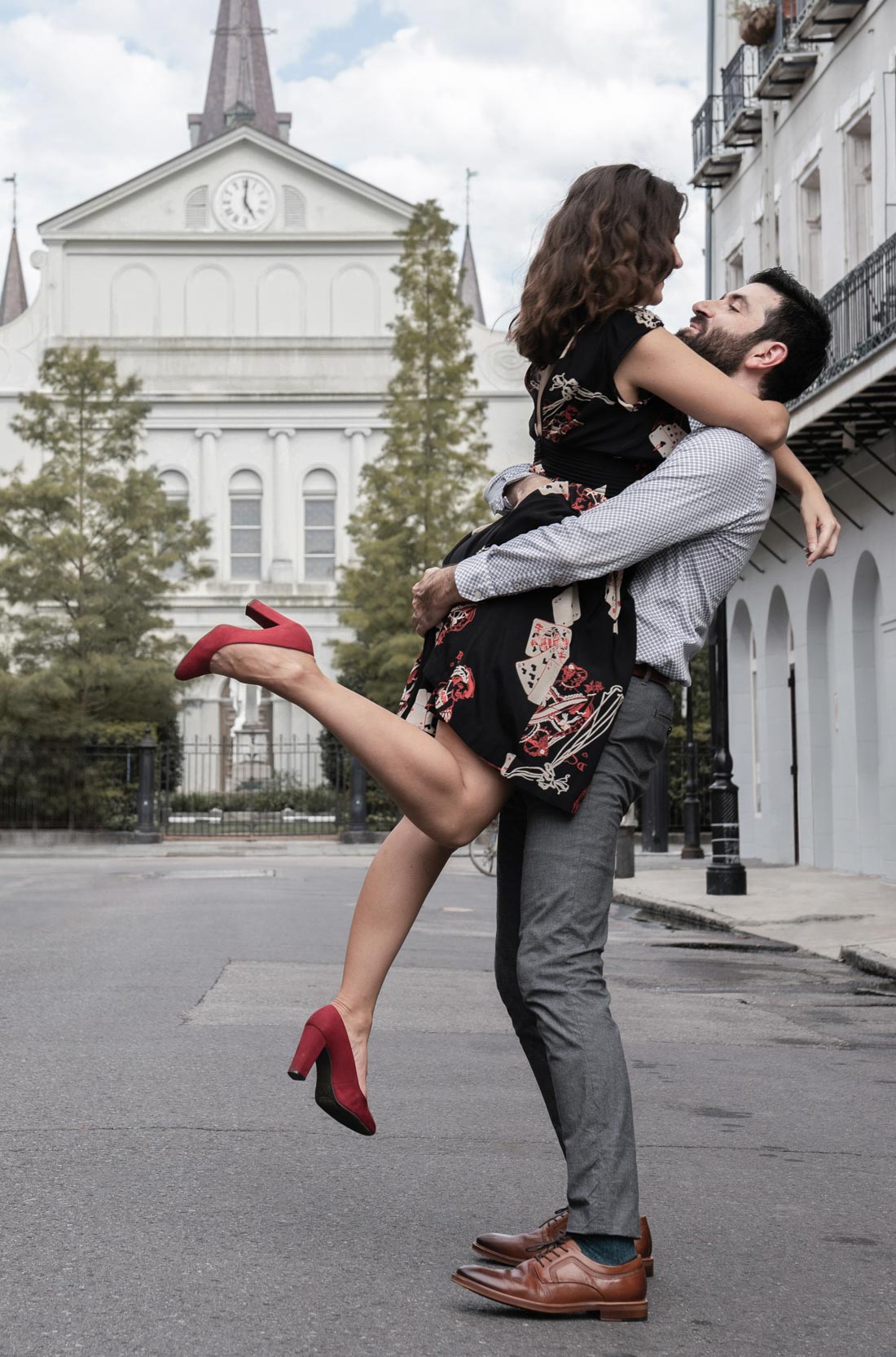 Romantic couple dacning and holding each other in the New Orleans French Quarter with cathedral in background