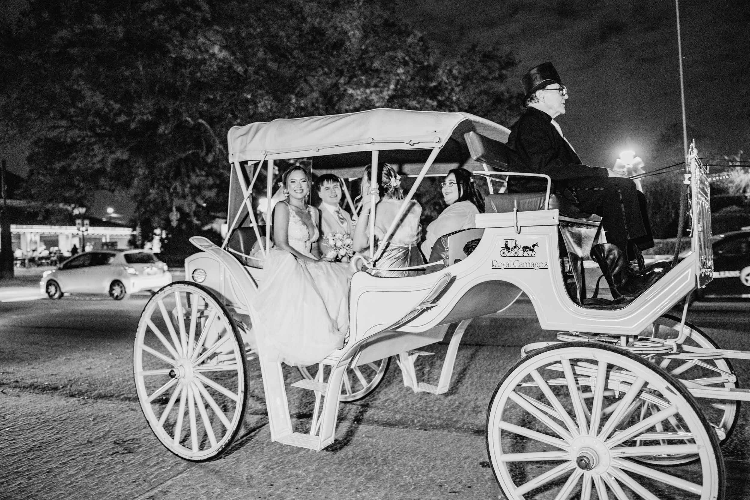 wedding carriage with bridal party in The French Quarter of New Orleans