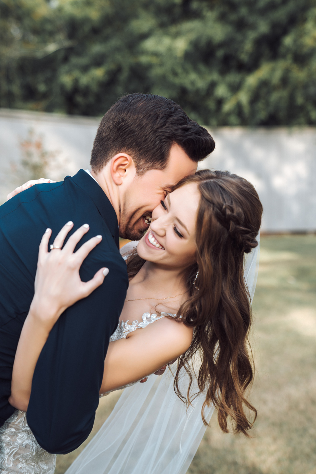 bride and groom laughing during first look at First Baptist church in Covington, Louisiana