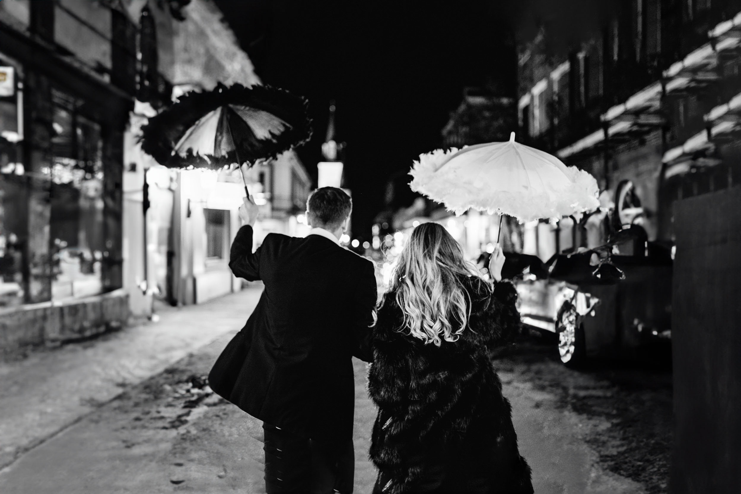 bride and groom celebrating with umbrellas on wedding day in the French Quarter of New Orleans