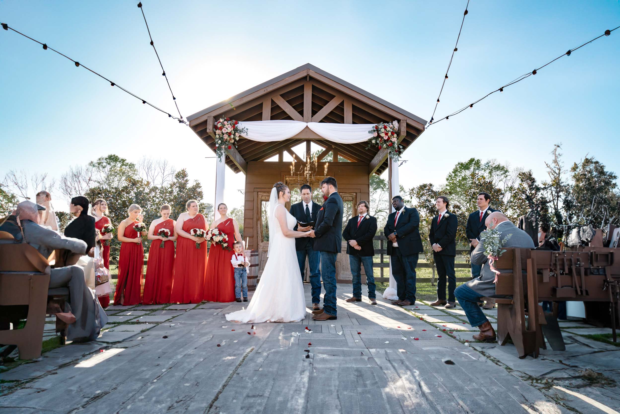 wedding ceremony under an arbor of flowers at Berry Barn in Amite, Louisiana