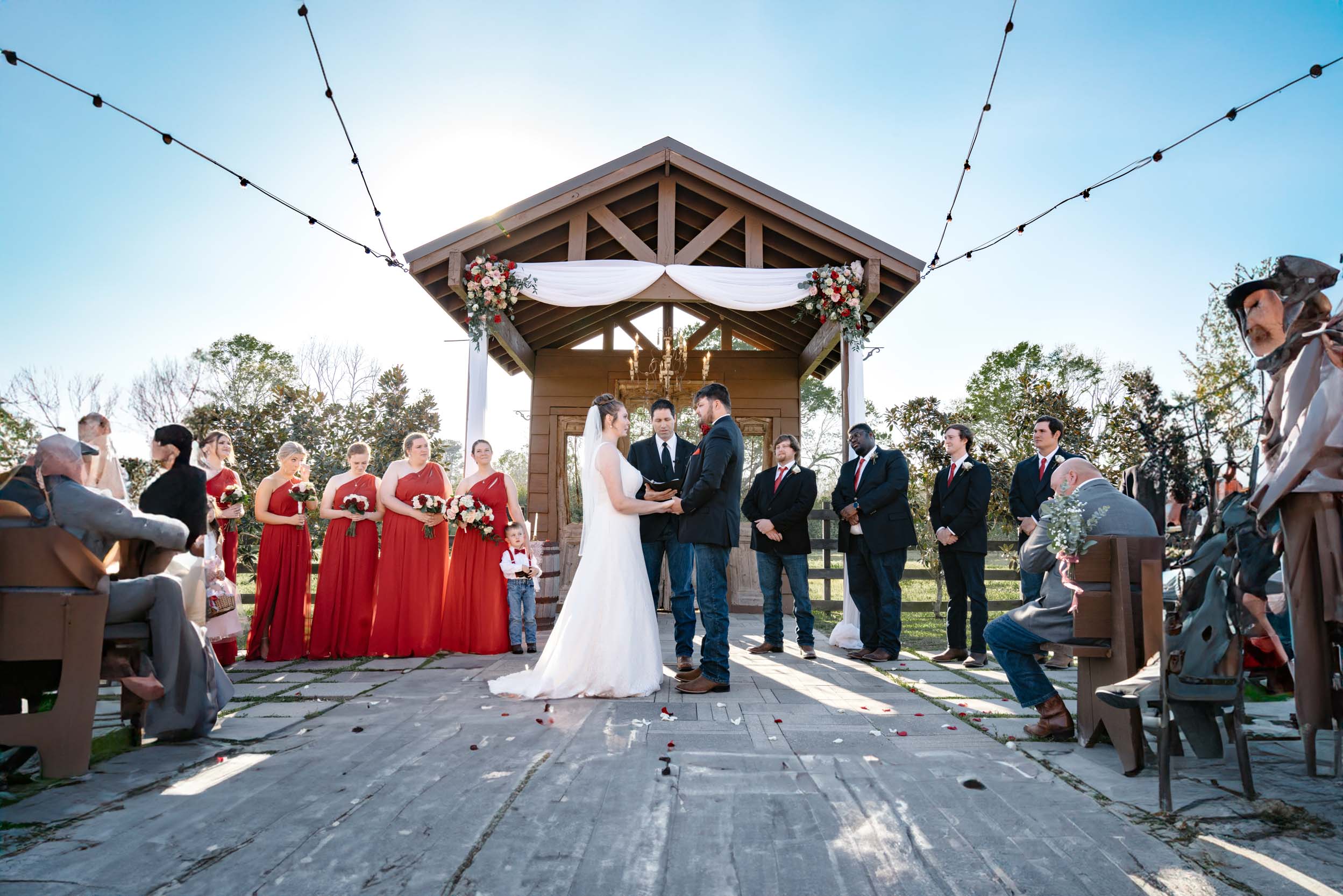 wedding ceremony under an arbor of flowers at Berry Barn in Amite, Louisiana