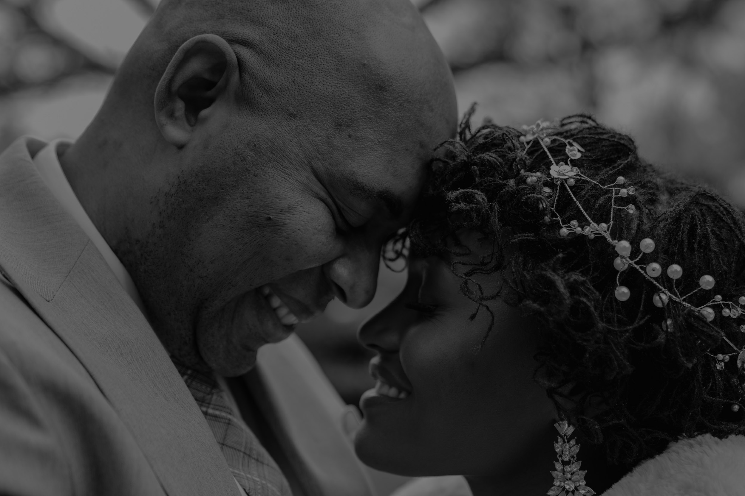 bride and groom touching foreheads and smiling on wedding day
