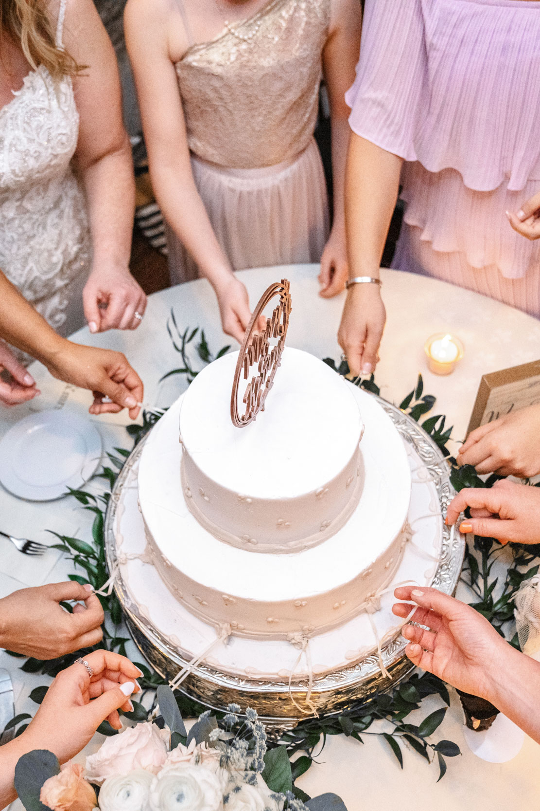 Cake pull with bride and bridesmaids during wedding reception at Hotel Mazarin in The French Quarter of New Orleans