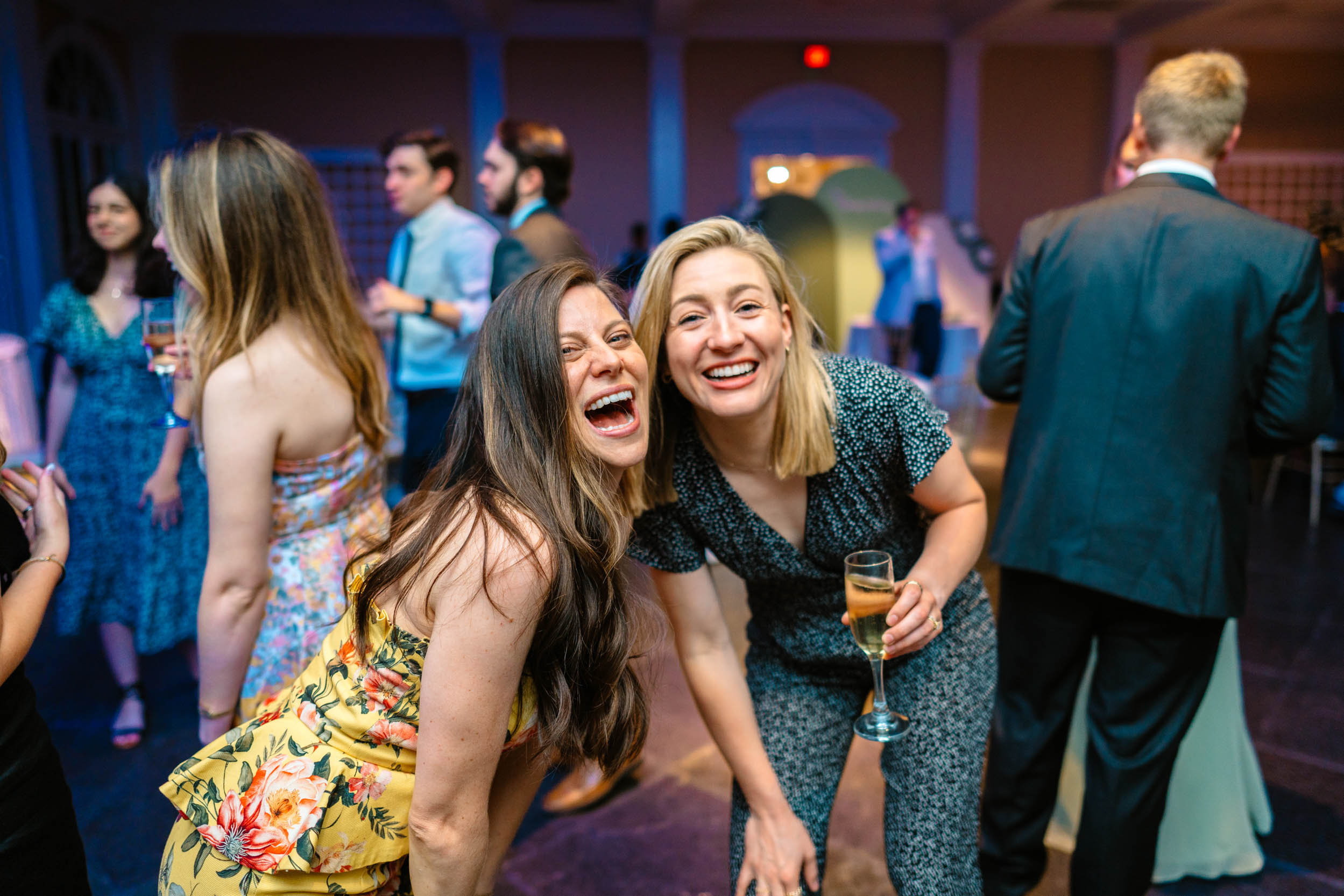 wedding guests laughing with champagne at reception at Pavilion of the two sisters in New Orleans