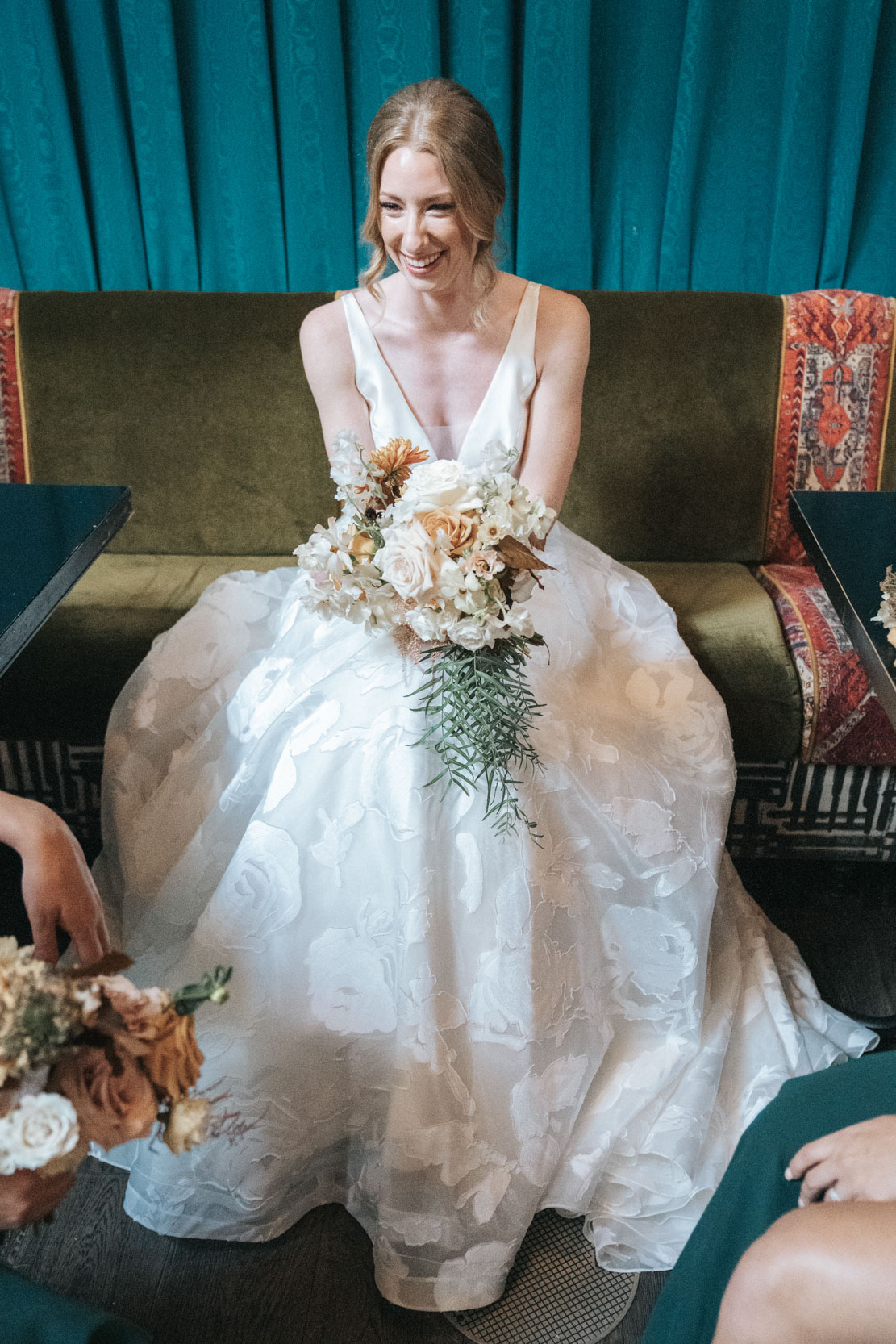 bride laughing with flowers in lobby of The Pontchartrain Hotel in New Orleans