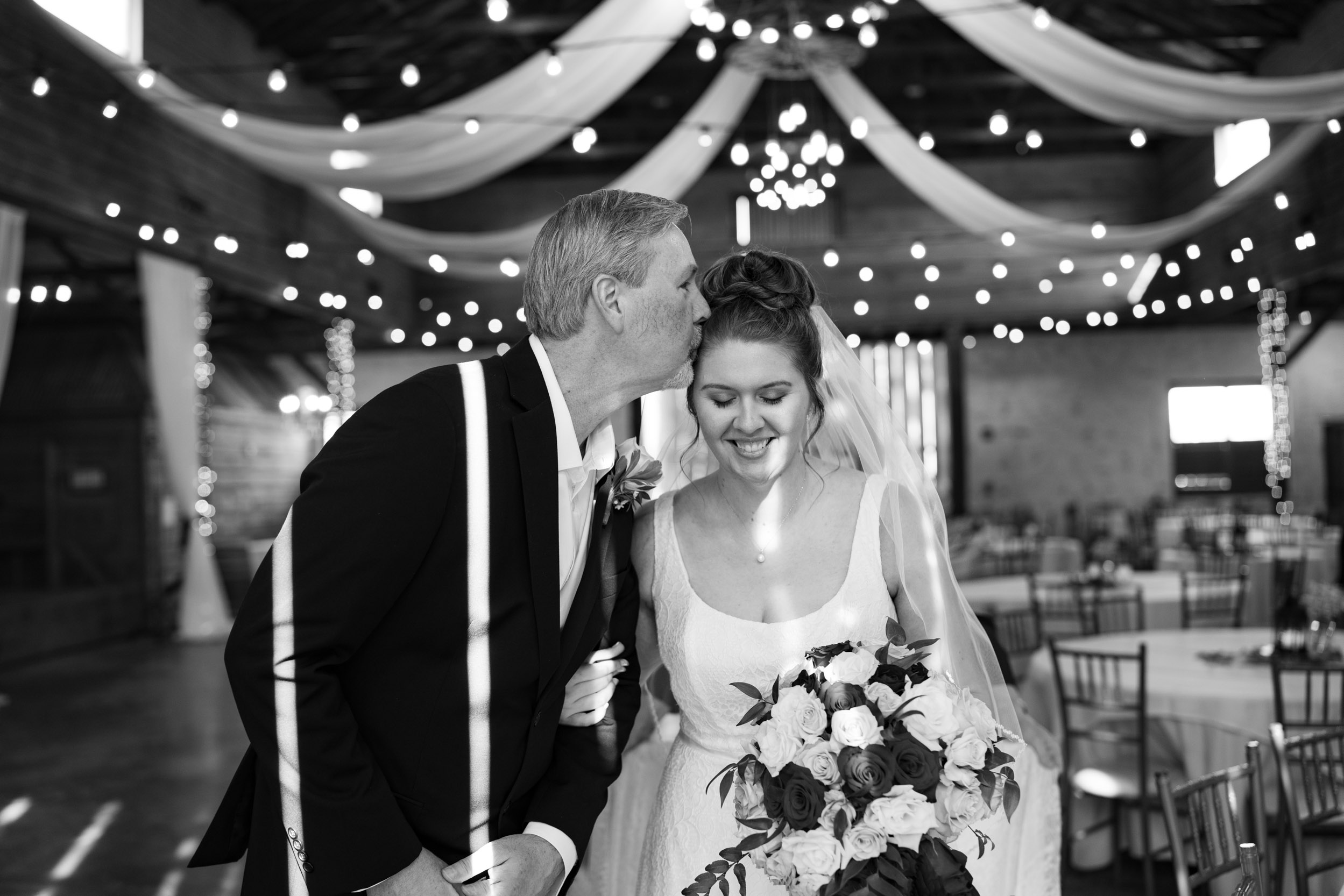 father of the bride kissing his daughter before wedding ceremony at Berry Barn in Amite, Louisiana