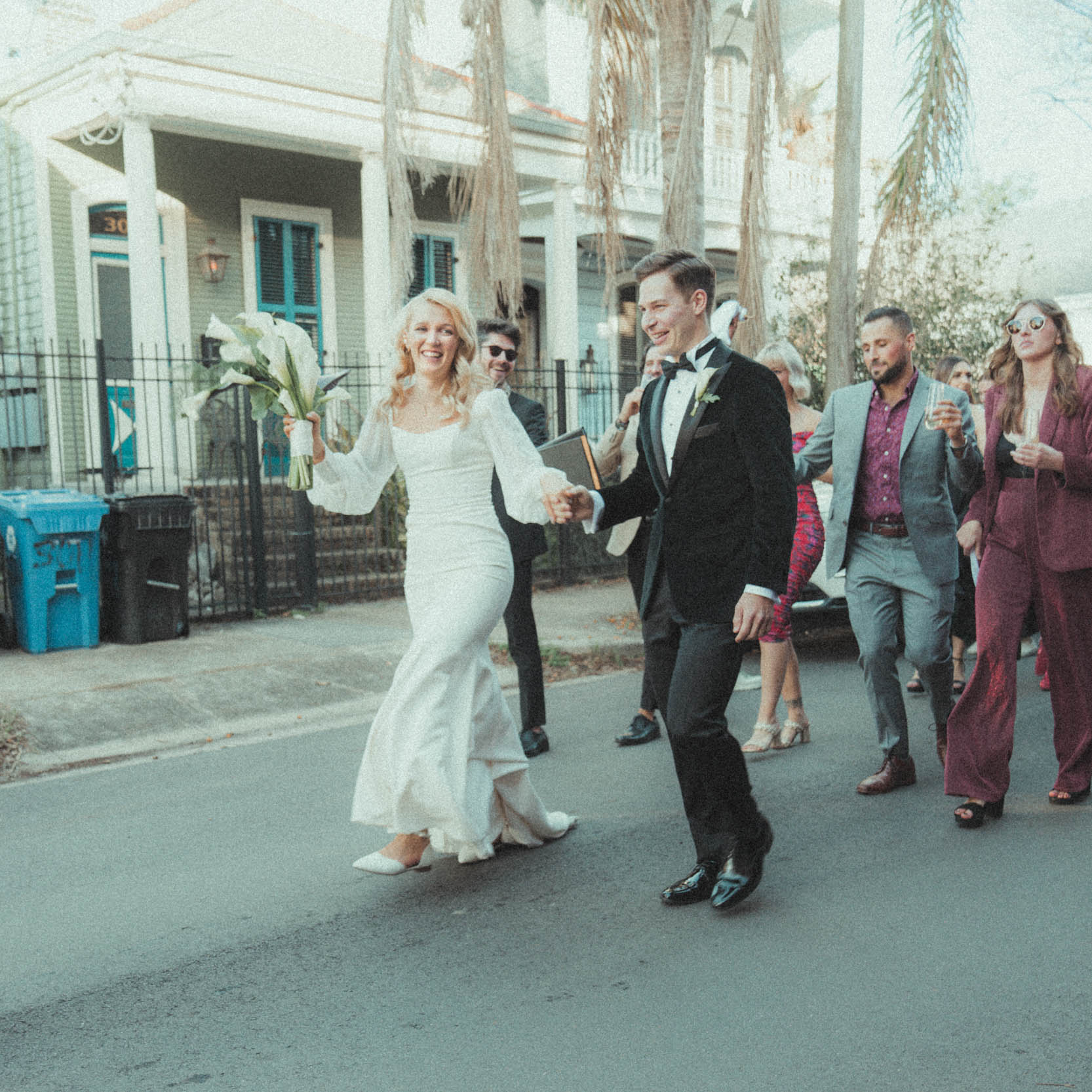 Bride and groom dancing during 2nd line parade in New Orleans