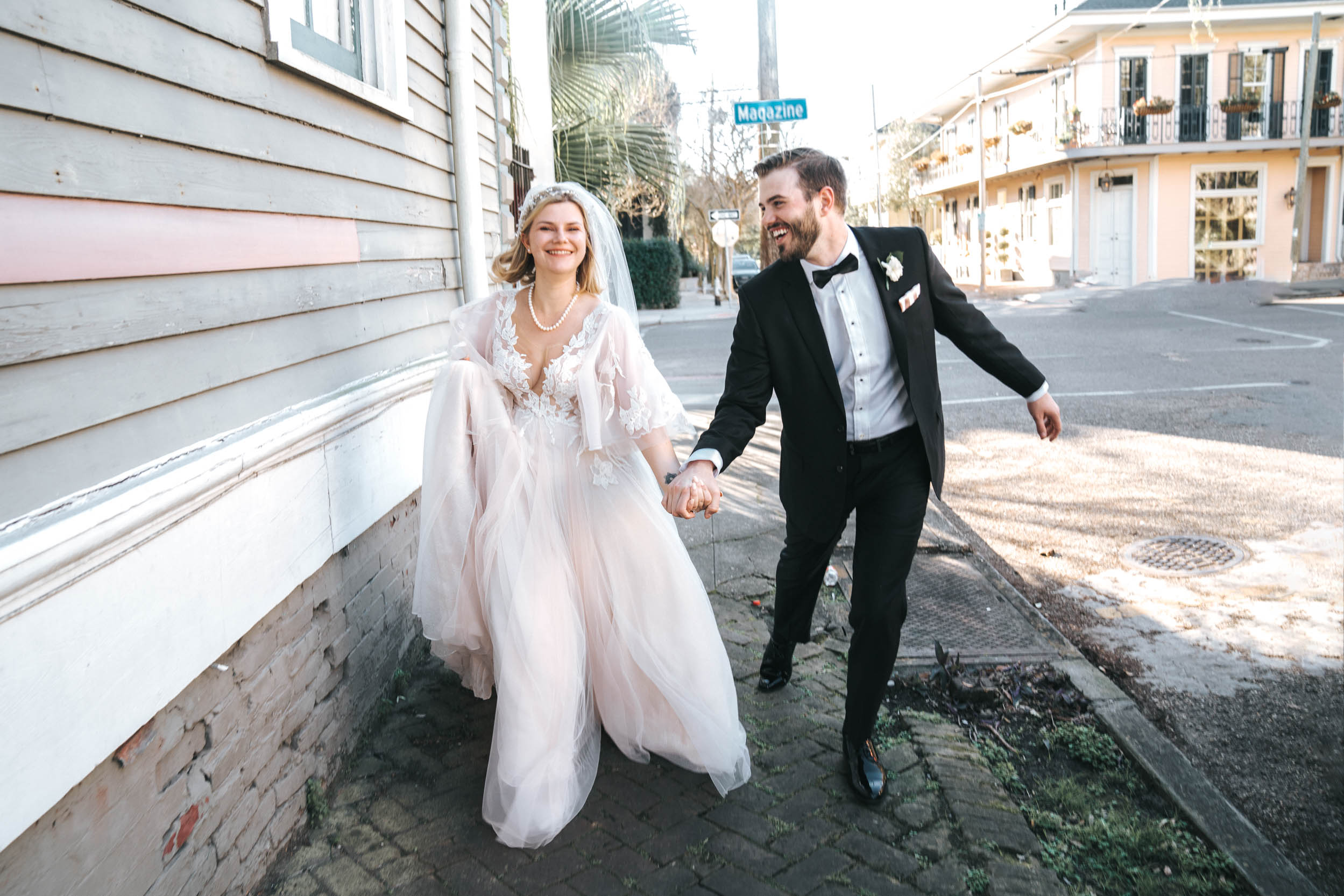 bride and groom walking down uptown neighborhood in Garden District of New Orleans