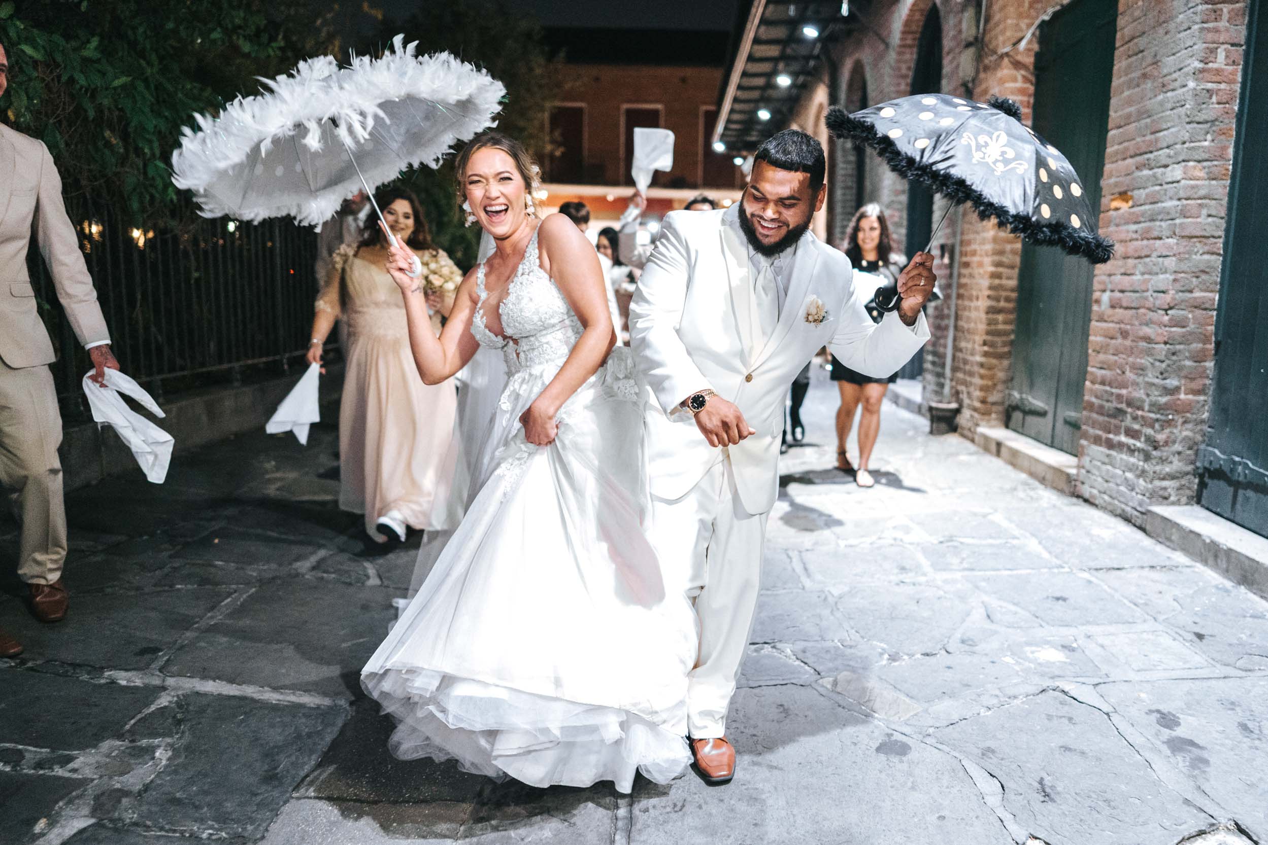 second line band parade on wedding day in French Quarter with parasols