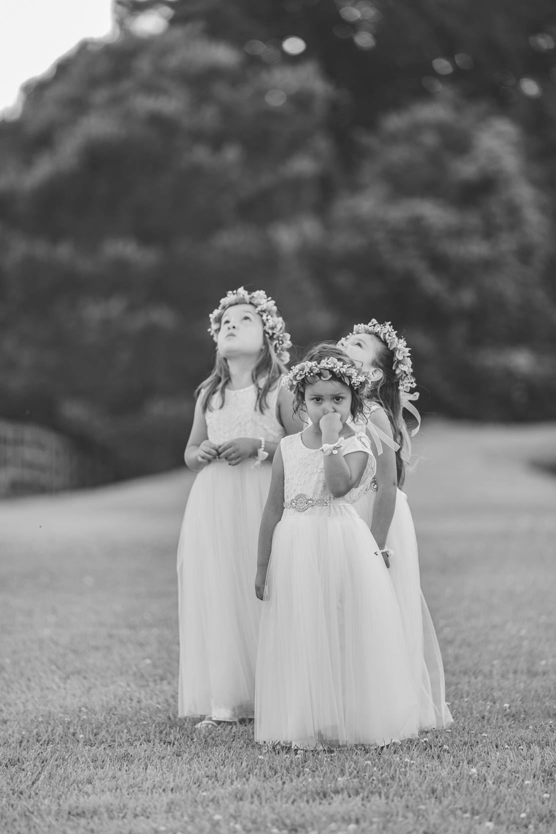 flower girls playing in a field at White Magnolia in Kentwood, Louisiana