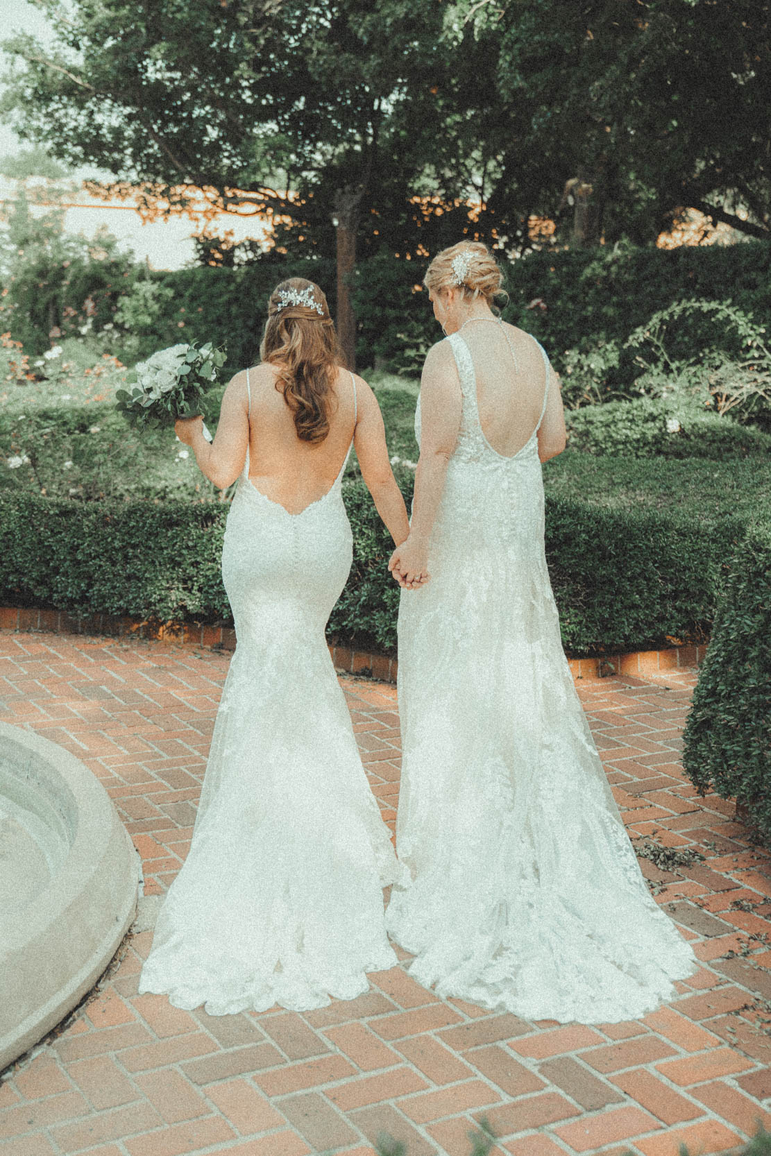 Brides holding hands at the City Park Botanical Gardens