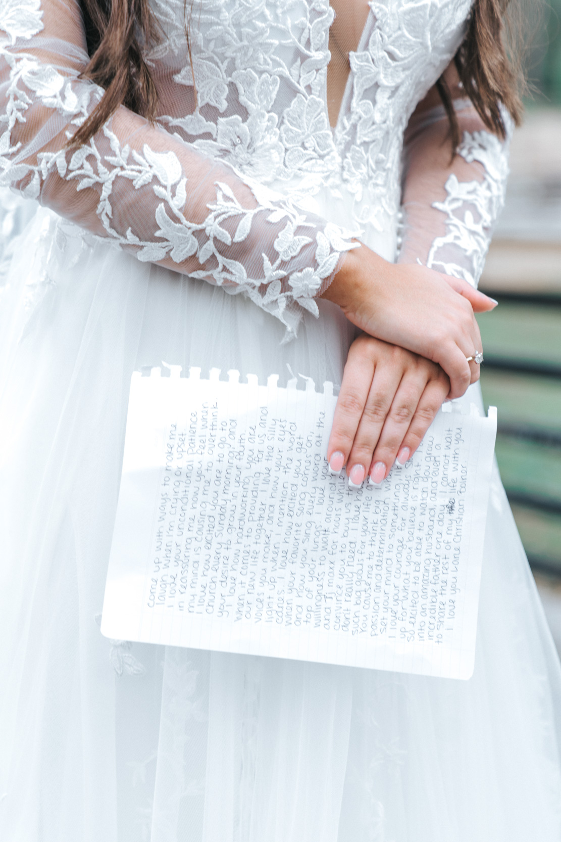 bride holding her vows and letter for the groom at Creekview Barn in Mississippi