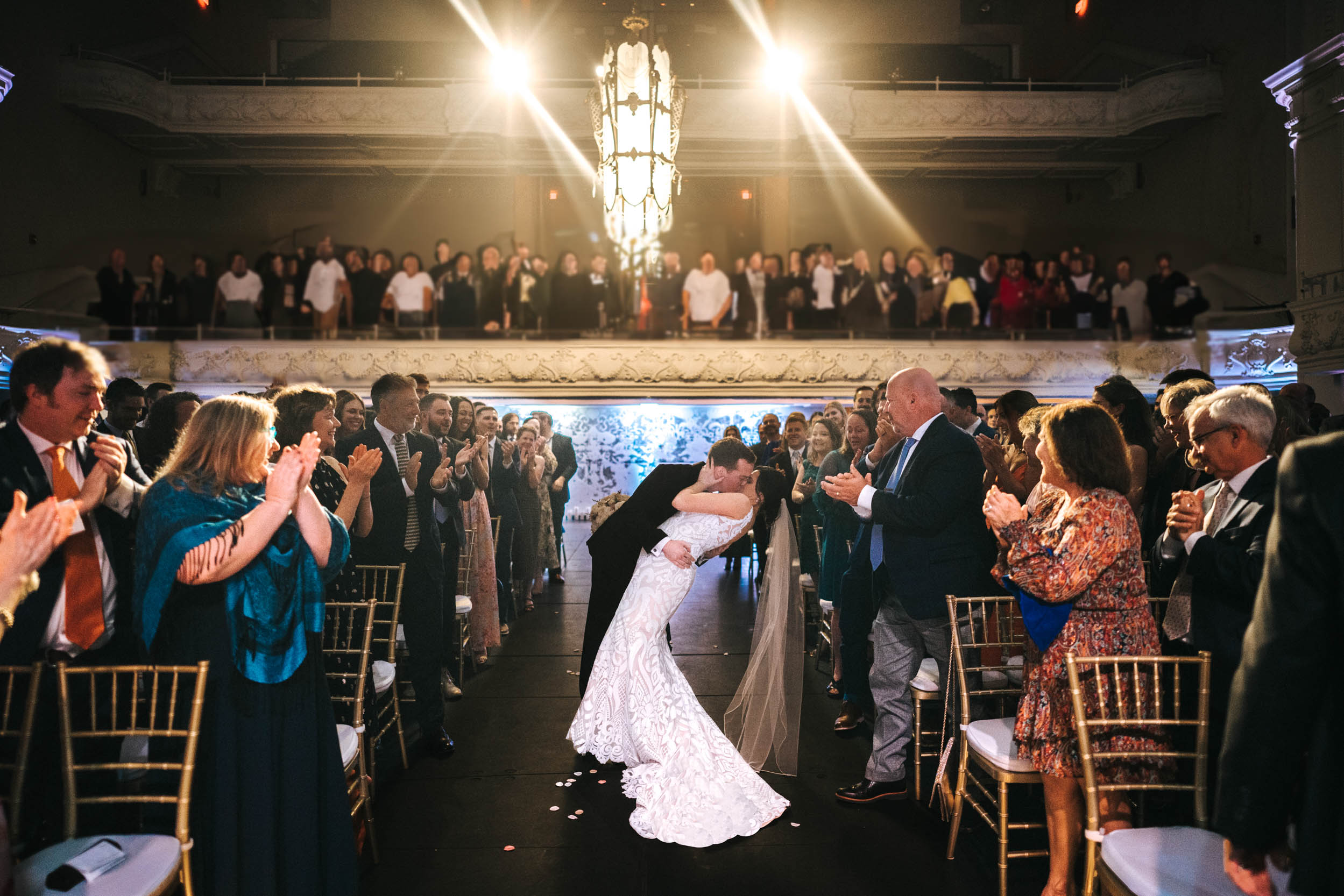 bride & groom exiting with kiss at wedding in Civic Theater New Orleans