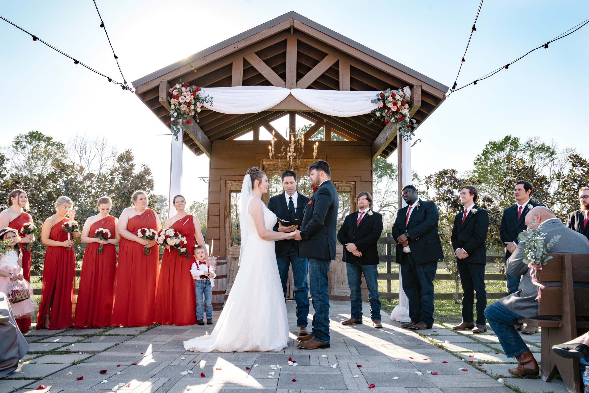 wedding ceremony under an arbor of flowers at Berry Barn in Amite, Louisiana