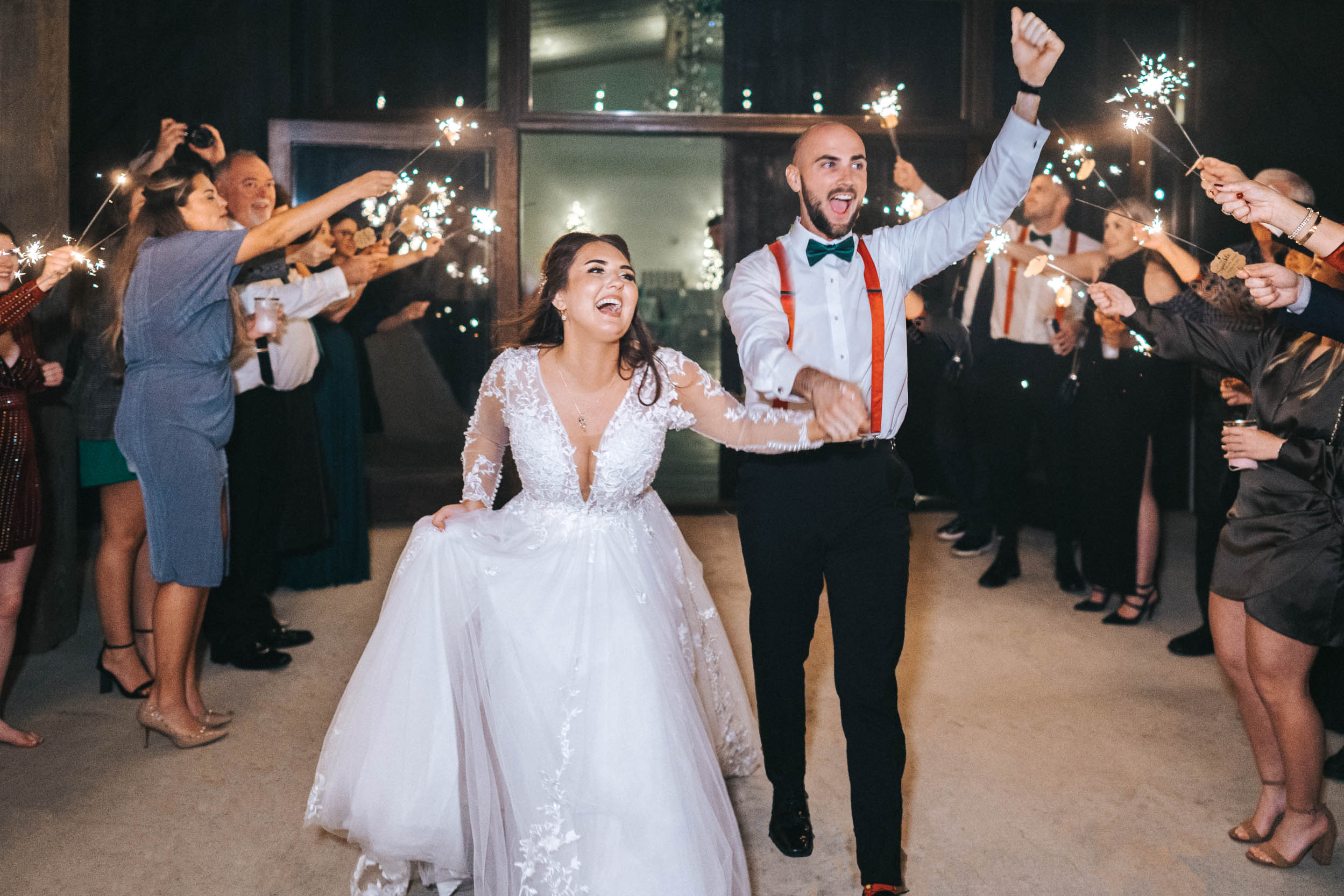 Bride and groom celebrating during sparkler exit at Creekview Barn in Mississippi