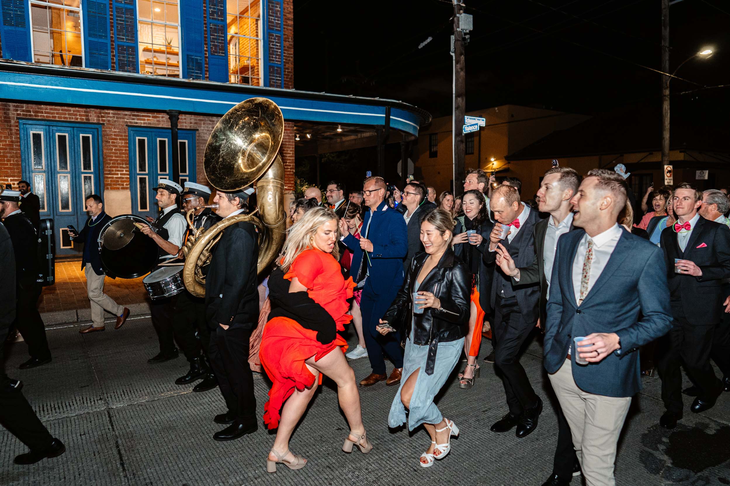 2nd line band procession with wedding guests on Tchoupitoulas Street at Rosy’s Jazz Hall in New Orleans