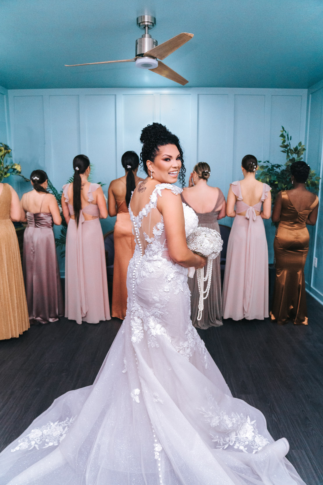 Beautiful African American bride looking back at camera for bridal reveal with her bridesmaids in New Orleans