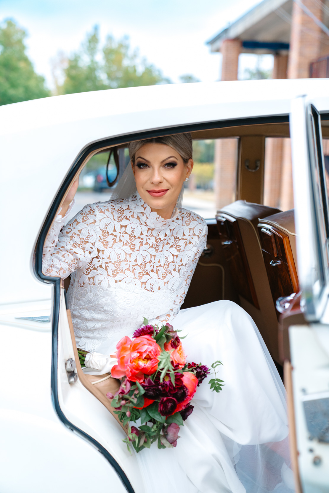 Bride sitting in Rolls-Royce with Petals and Parties flowers on wedding day at the Southern Hotel in Covington, Louisiana