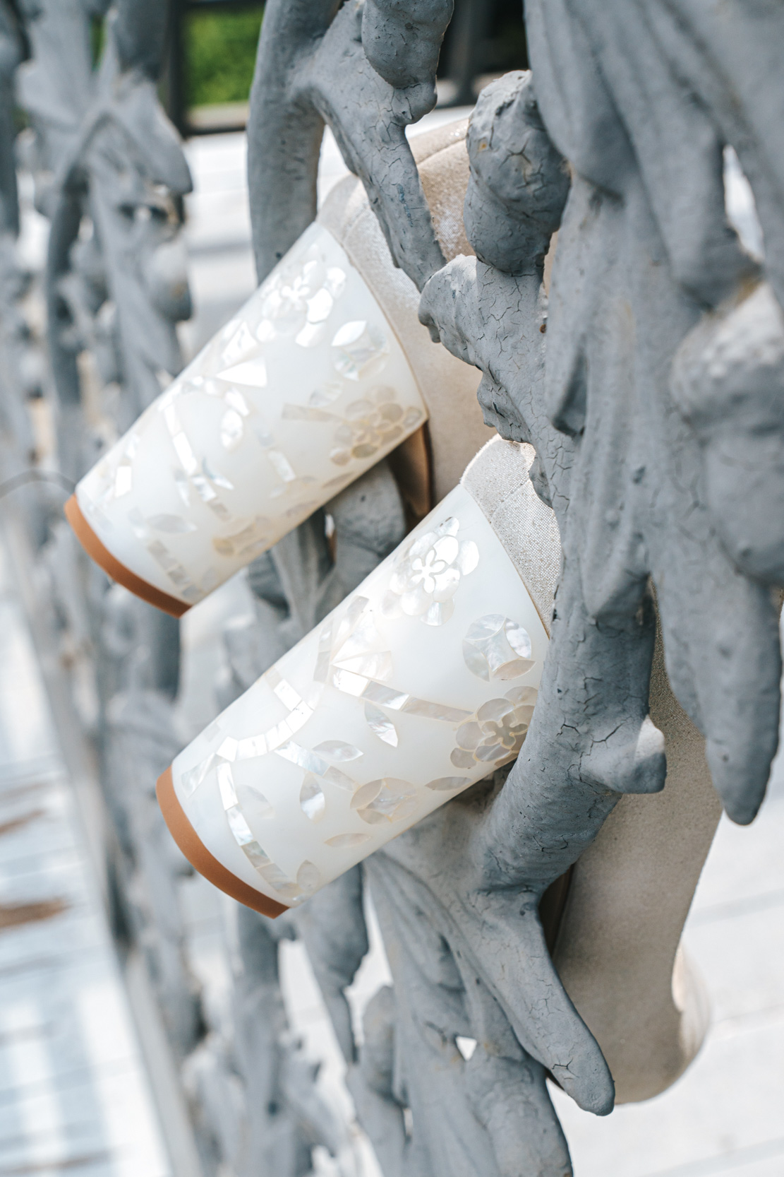 Freya Rose bridal shoes hanging on wrought iron balcony at Margaret Place in New Orleans