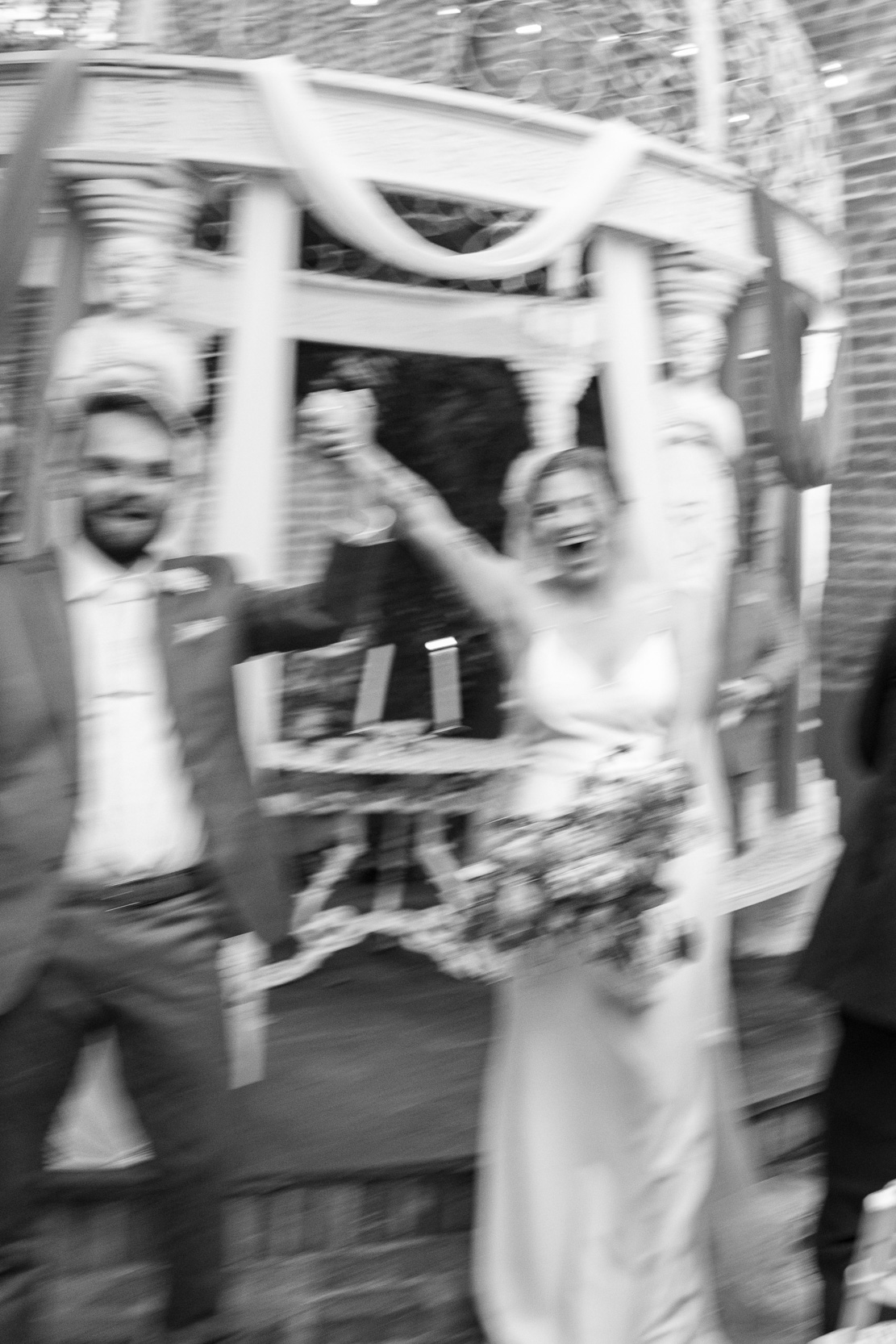 blurry wedding photo of bride and groom celebrating on their wedding day at Margaret Place in New Orleans