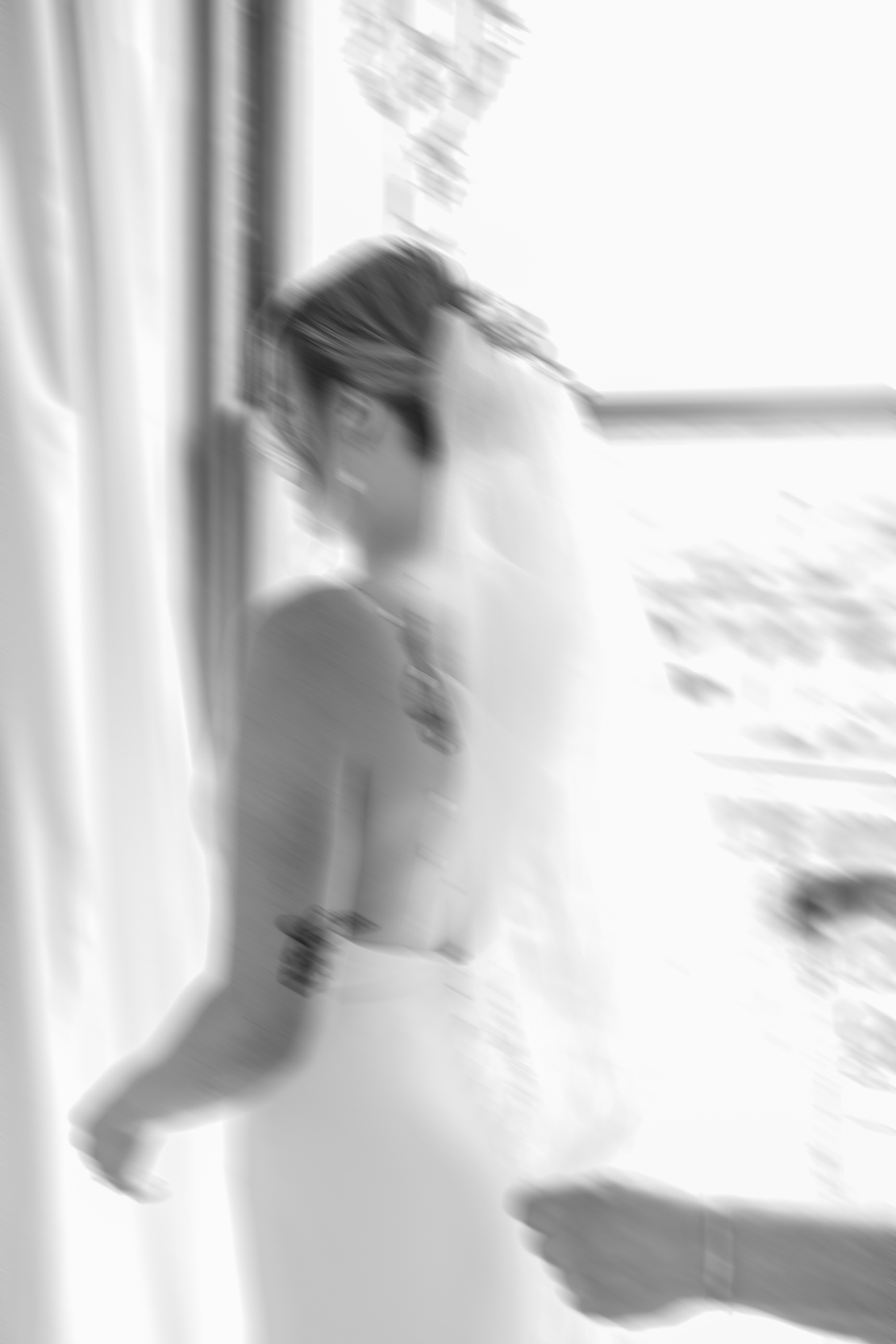 blurry wedding photo of bride putting on her veil at Margaret Place in New Orleans