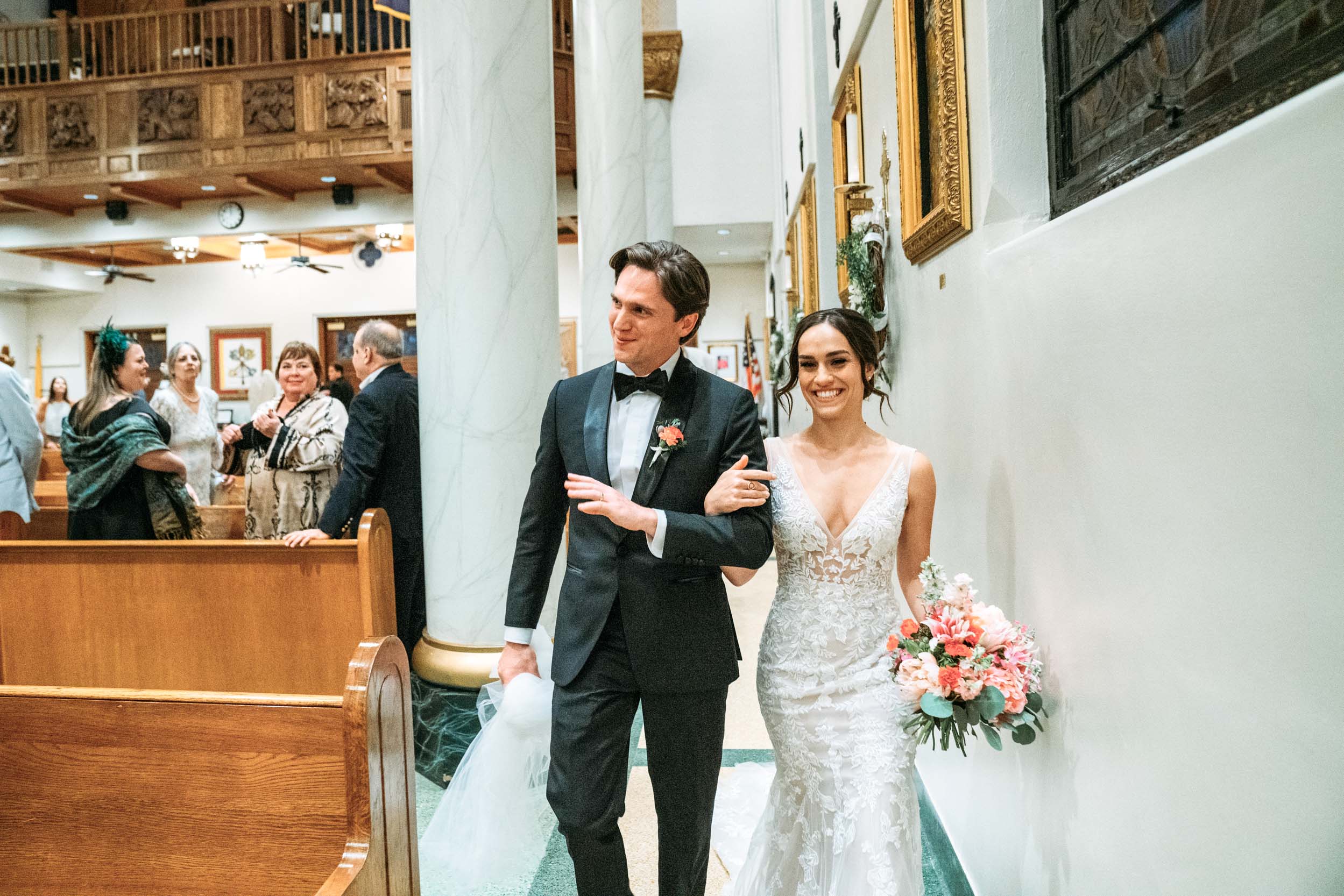 bride and groom celebrating and exiting wedding ceremony at a Our Lady of Lake Church in Covington, Louisiana