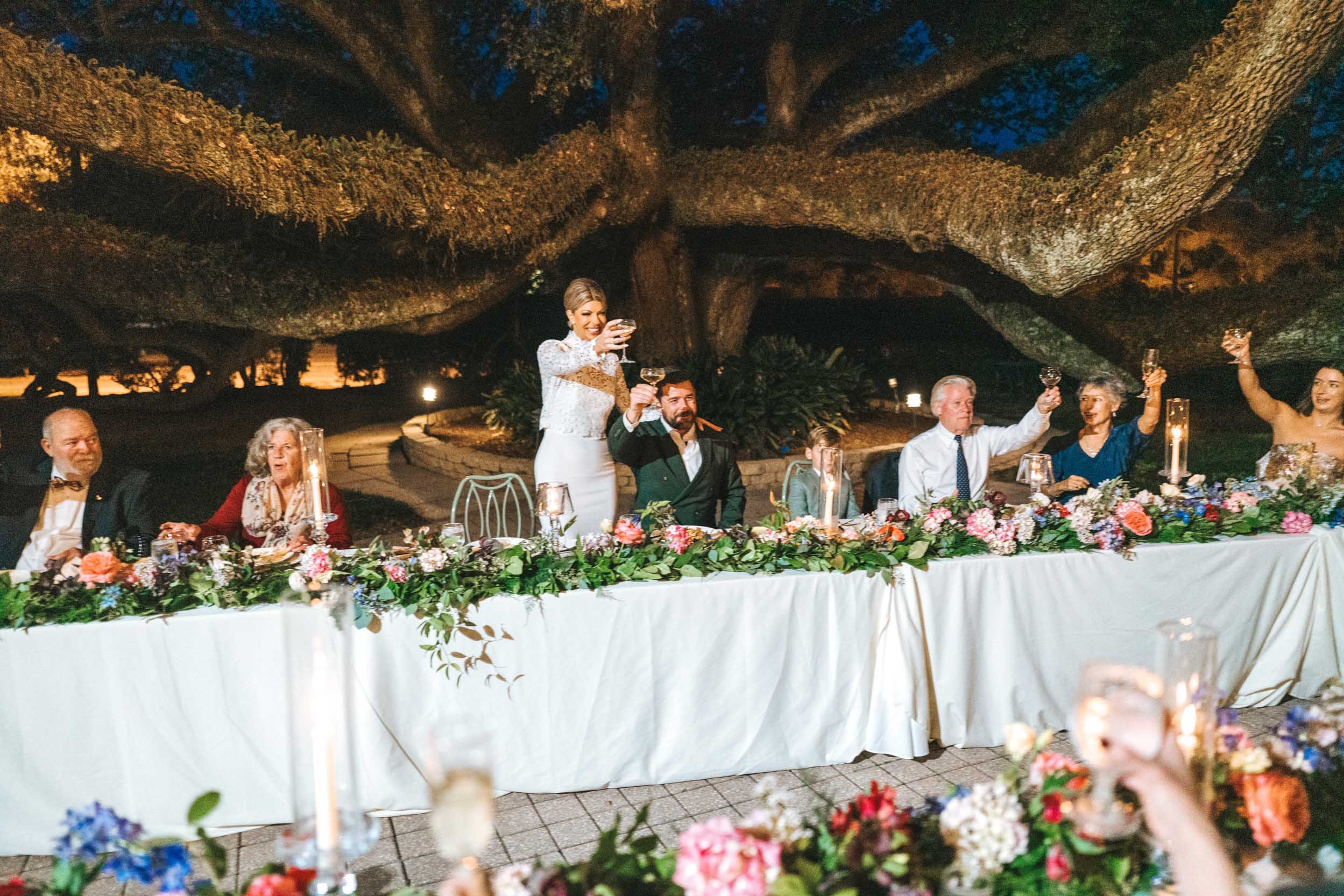 bride and groom celebrating and toasting with wedding guests during reception at The Greenwood Covington, Louisiana