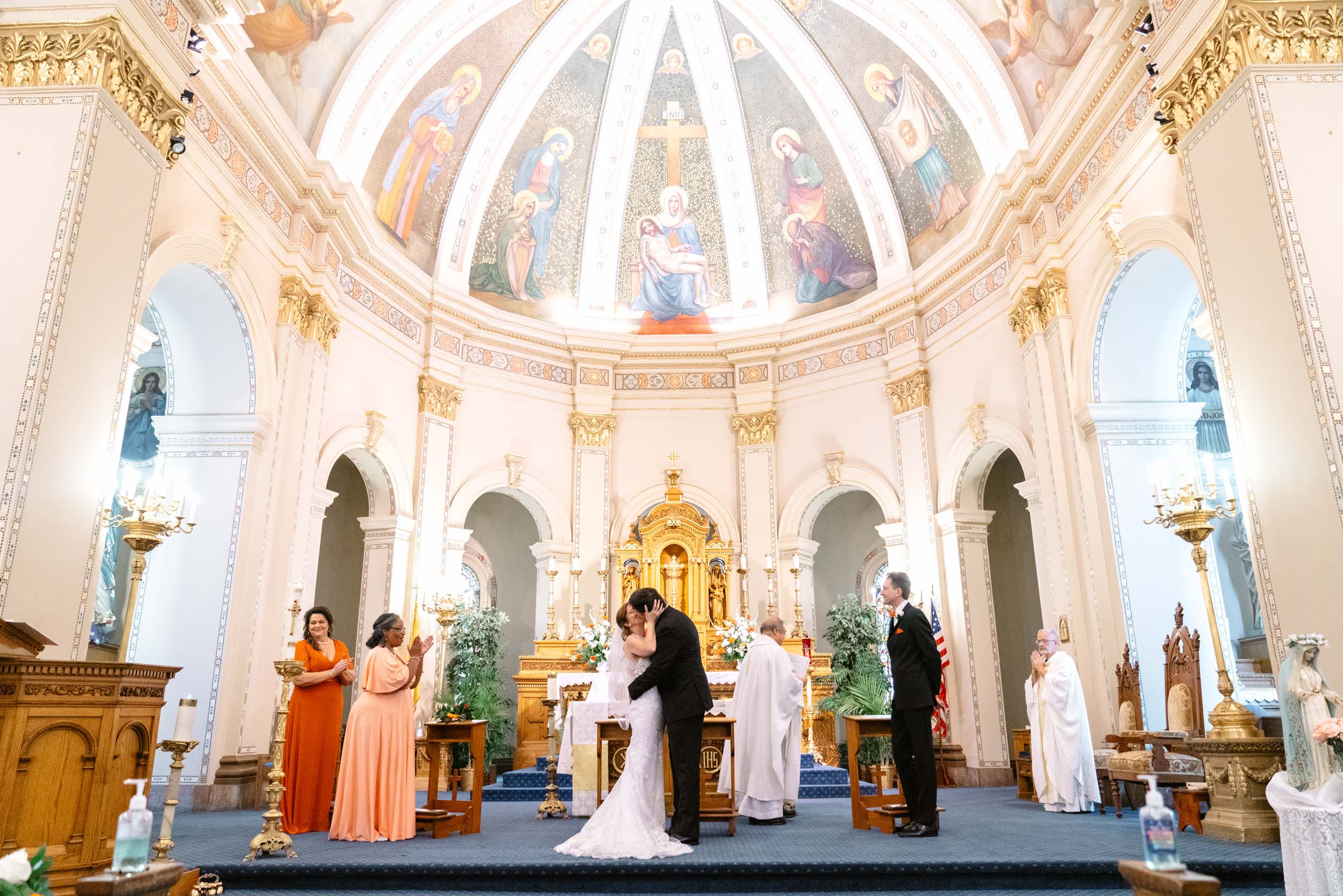 bride and groom kissing during wedding ceremony inside the beautiful at Mater Dolorosa Church in New Orleans