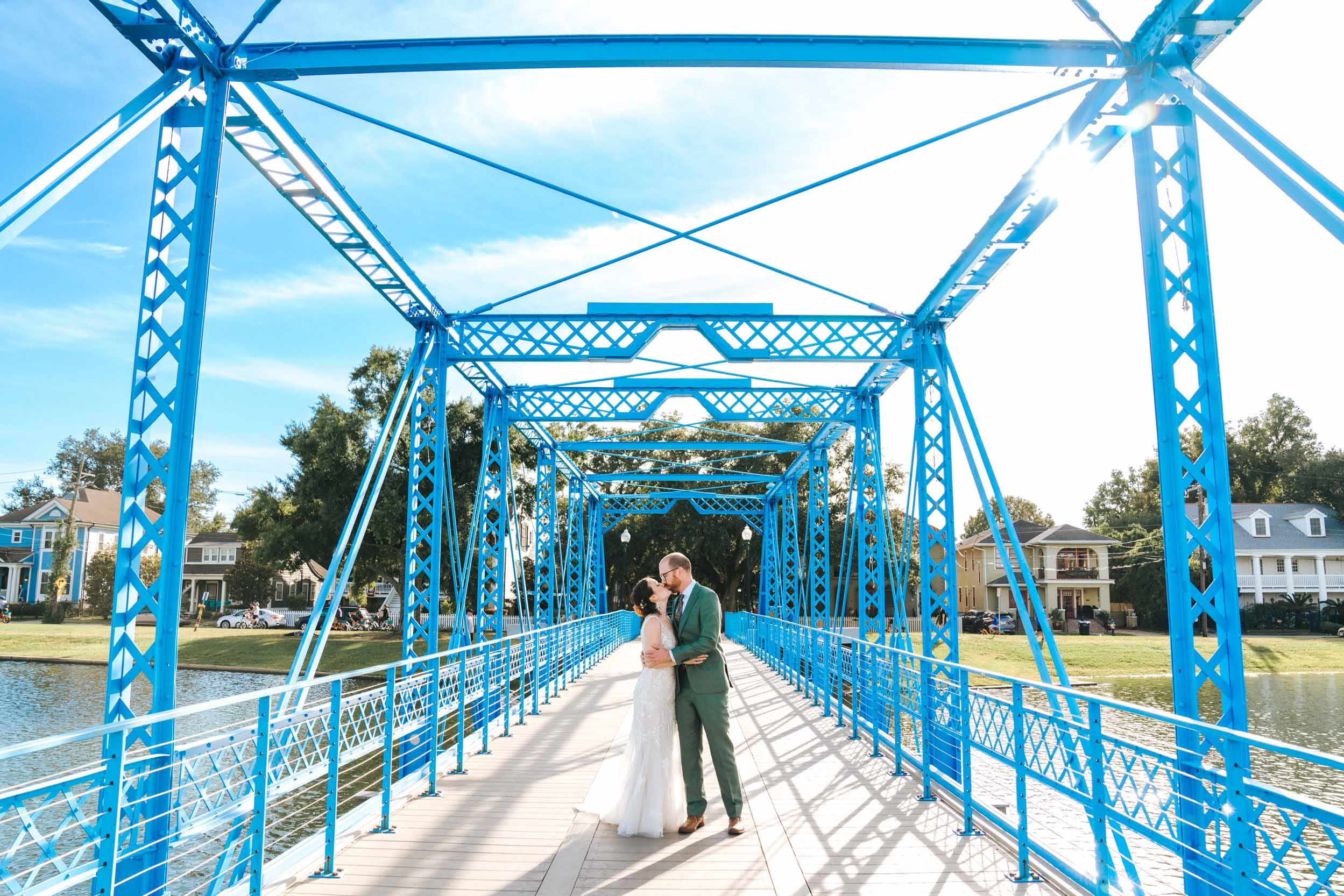 bride and groom kissing on the blue Magnolia bridge in New Orleans, Louisiana