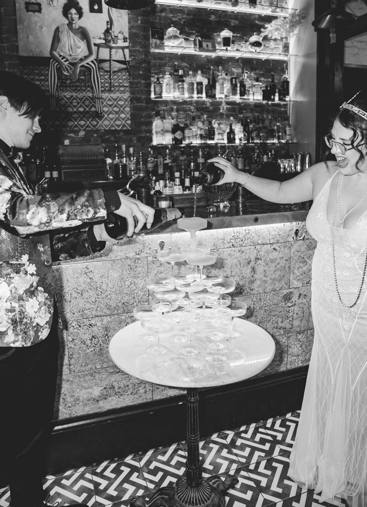 bride and groom pouring wine over champagne tower at the Historic Swoop Duggins House in New Orleans