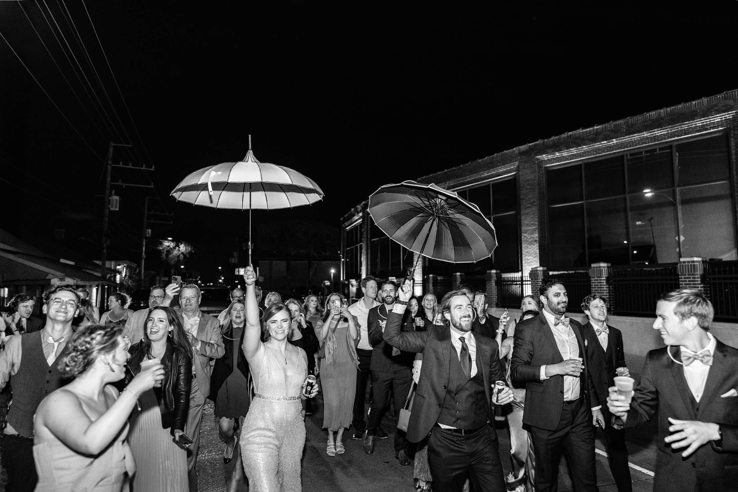 bride and groom with wedding guests during 2nd line band celebration on Tchoupitoulas Street at Rosy’s Jazz Hall in New Orleans