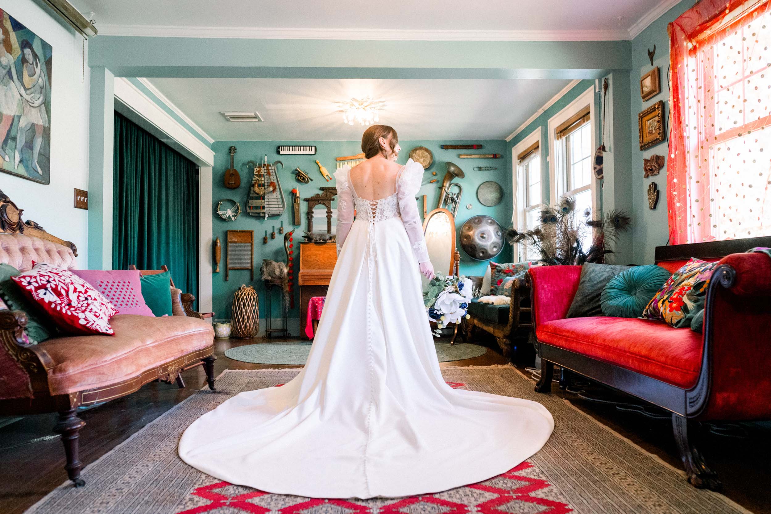 bride holding her flowers in colorful rustic room at Emerald Door in the Bywater New Orleans