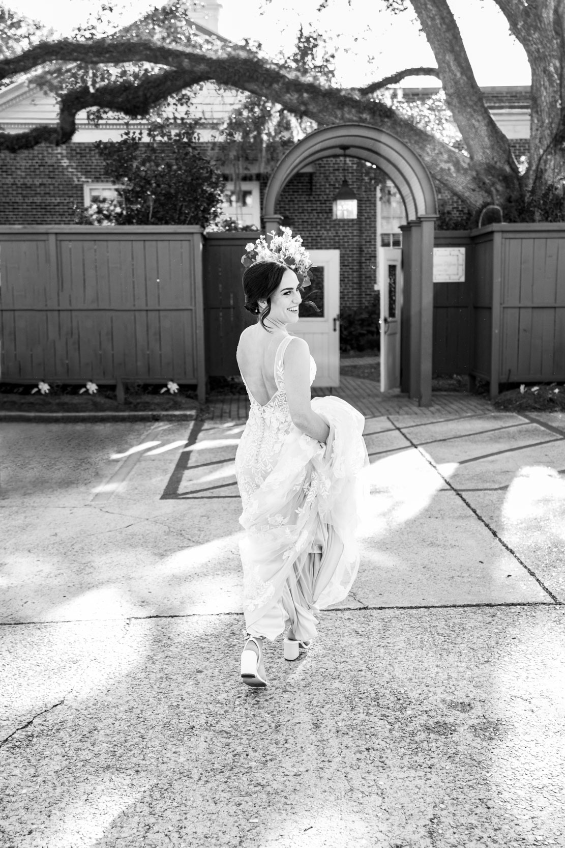 bride running with flowers in the parking lot of The Southern Hotel in Covington, Louisiana