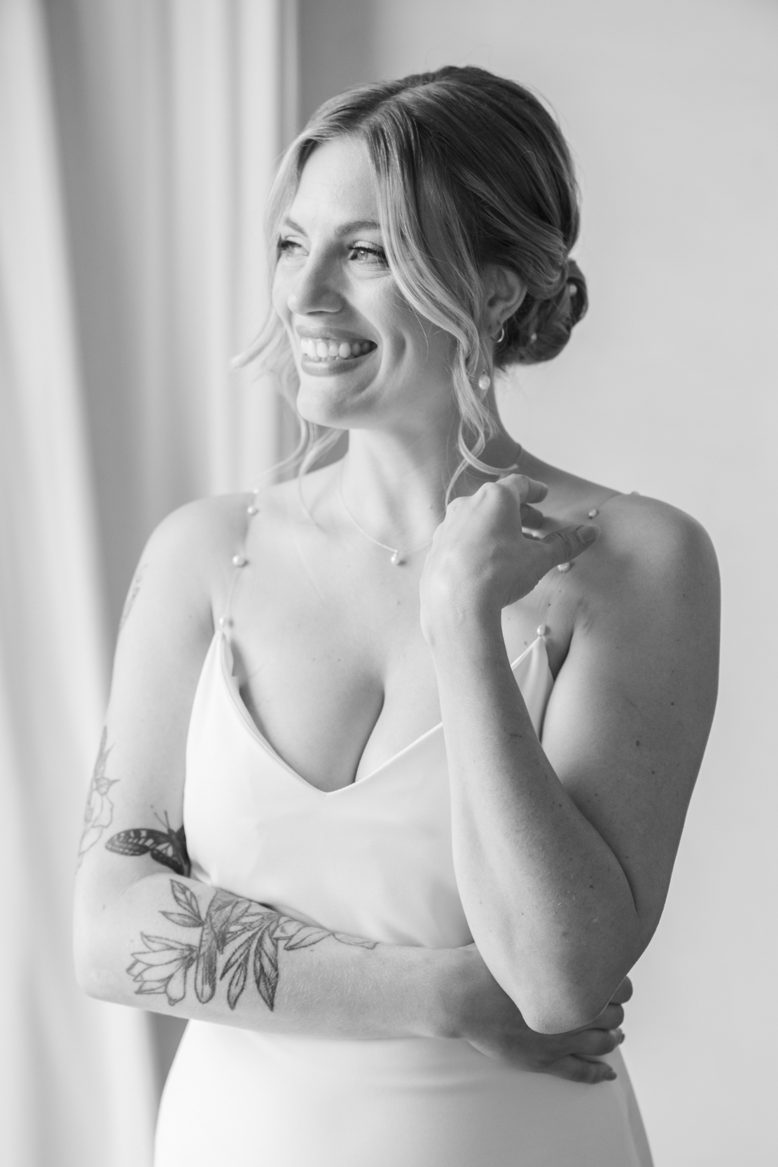 bride smiling and looking out window at Margaret Place in New Orleans