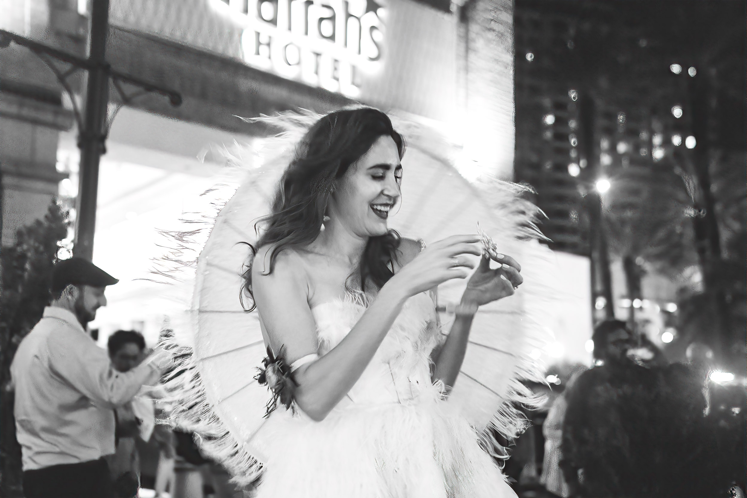 bride smiling while wind blows on wedding day in New Orleans French Quarter