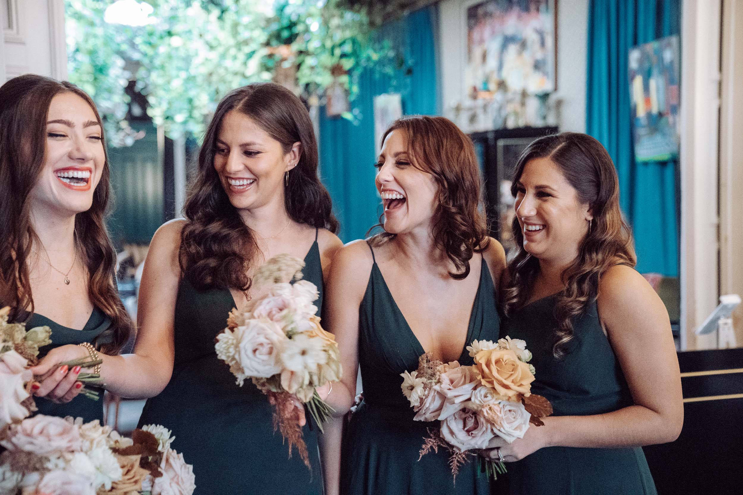 bridesmaids laughing with flowers in lobby of The Pontchartrain Hotel in New Orleans