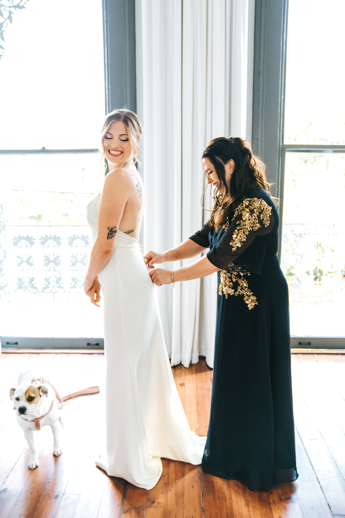 bride's mother buttoning bride's wedding dress on wedding day at Margaret Place in New Orleans