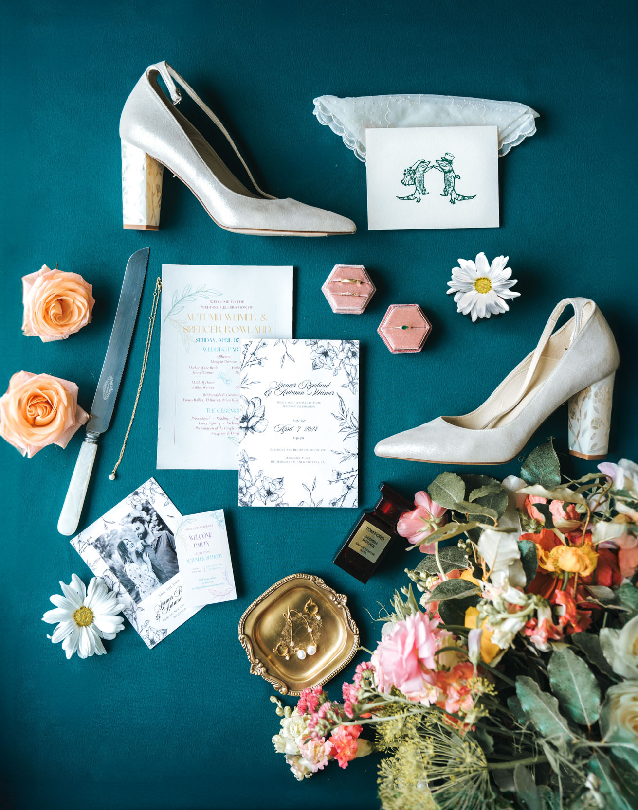 flat lay with Freya Rose bridal shoes, Cicada Calling flowers, Tom Ford perfume, Hotel Chloe invitation, Oore rings, roses, and daisies at Margaret Place in New Orleans