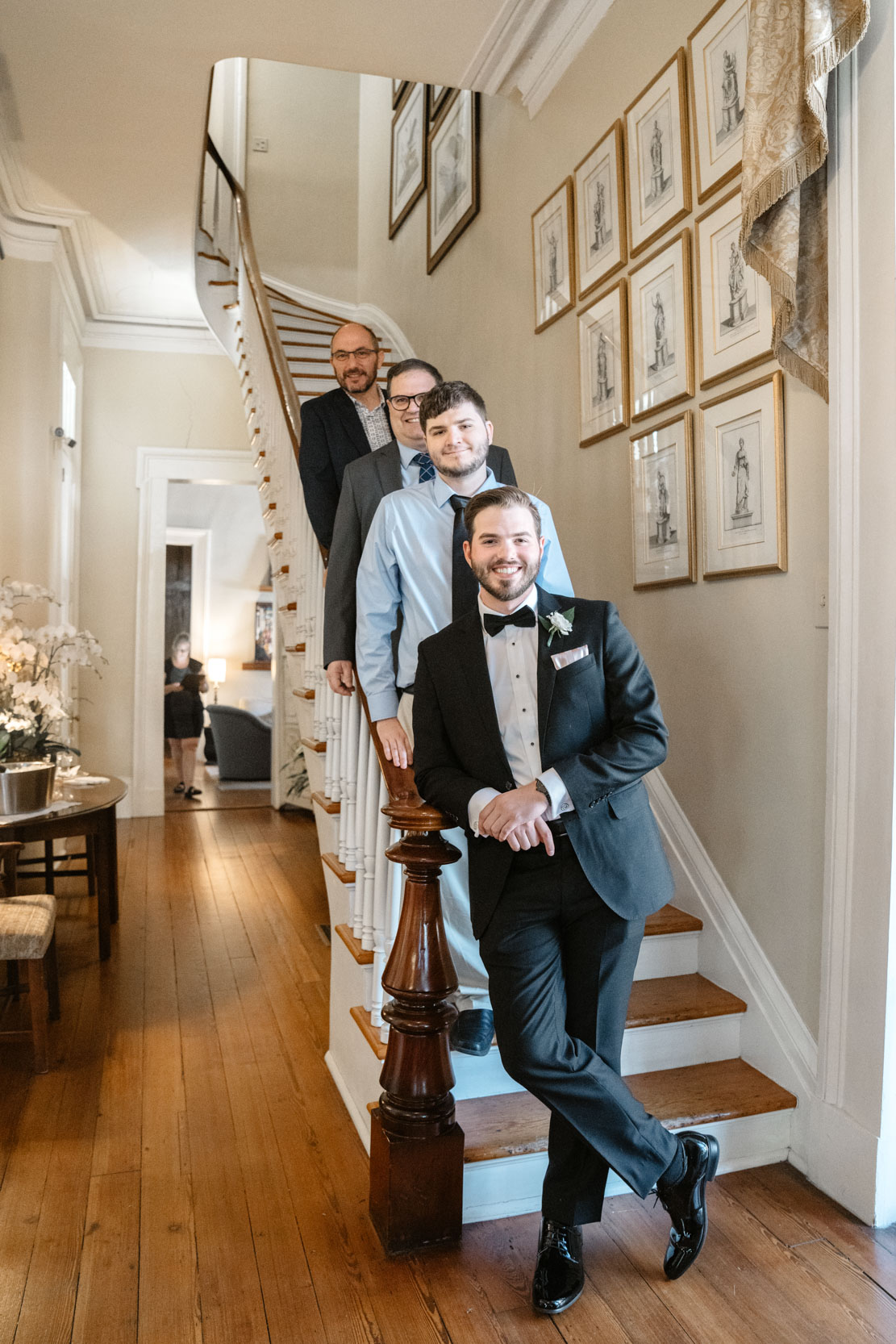 groom and groomsmen posing on stairs of old mansion (Terrell House) in Garden District of New Orleans