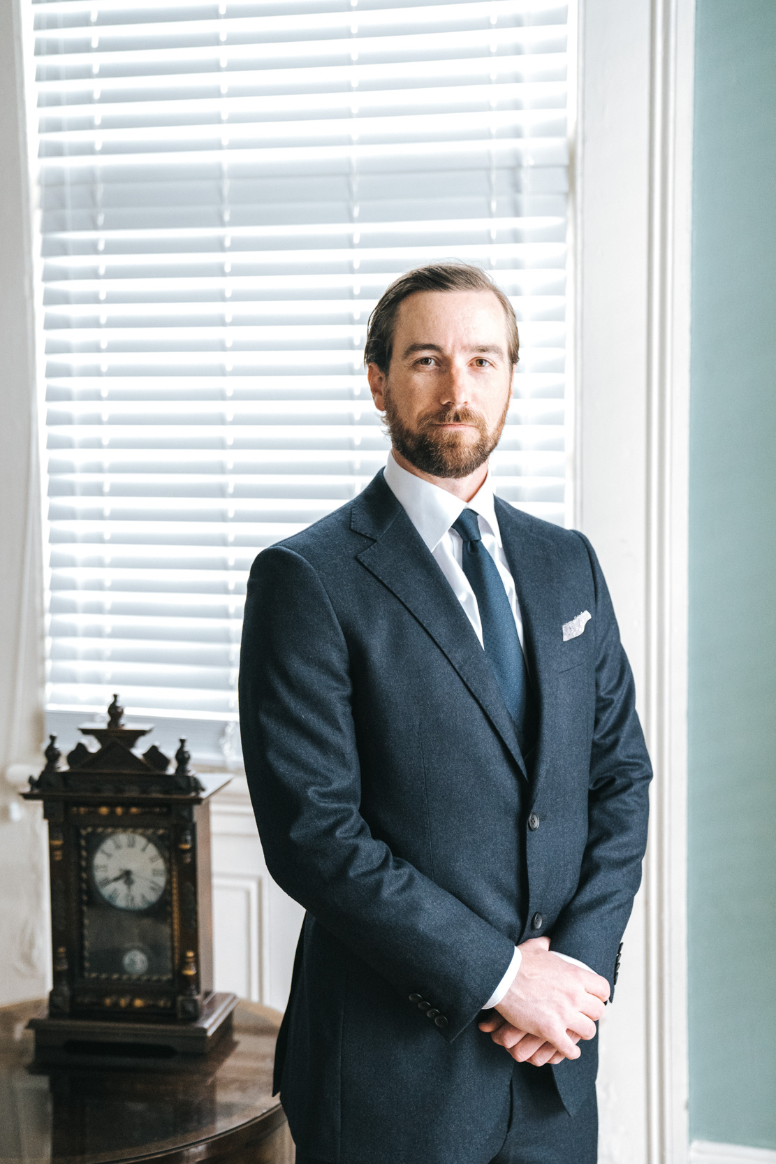 groom in navy blue suit on wedding day in the New Orleans Bywater