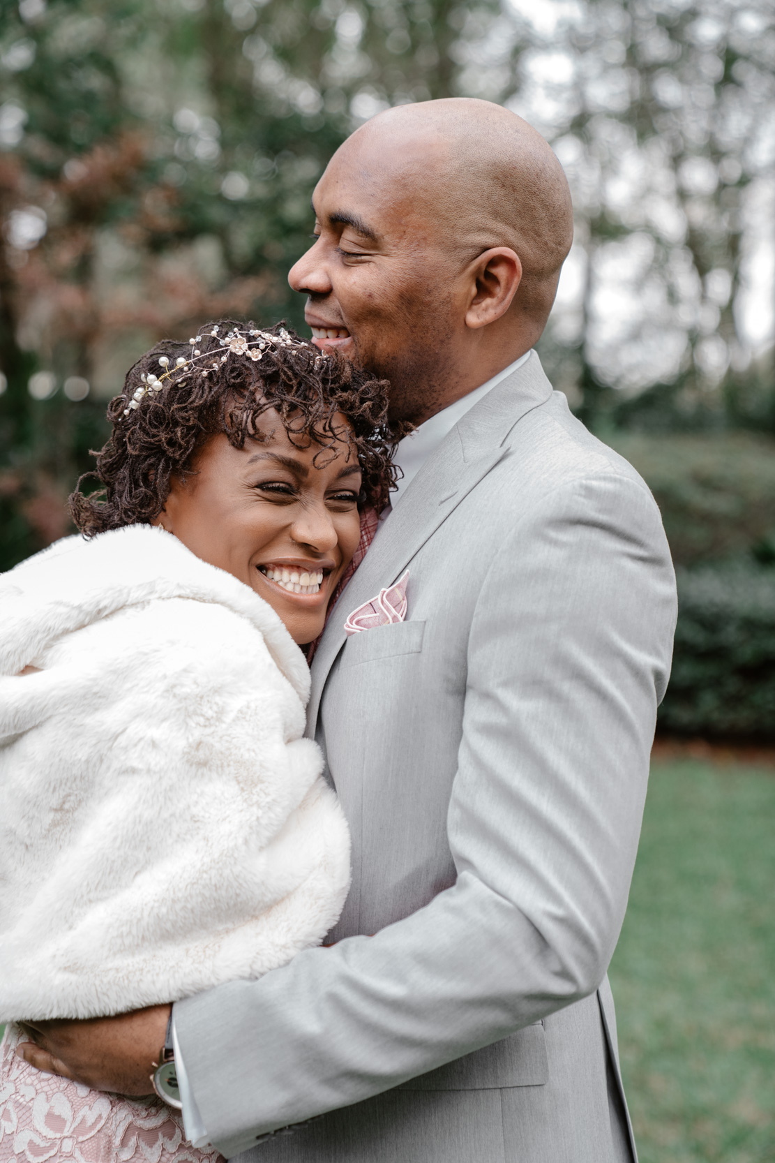 happy African American couple laughing on wedding day in Audubon Park in New Orleans