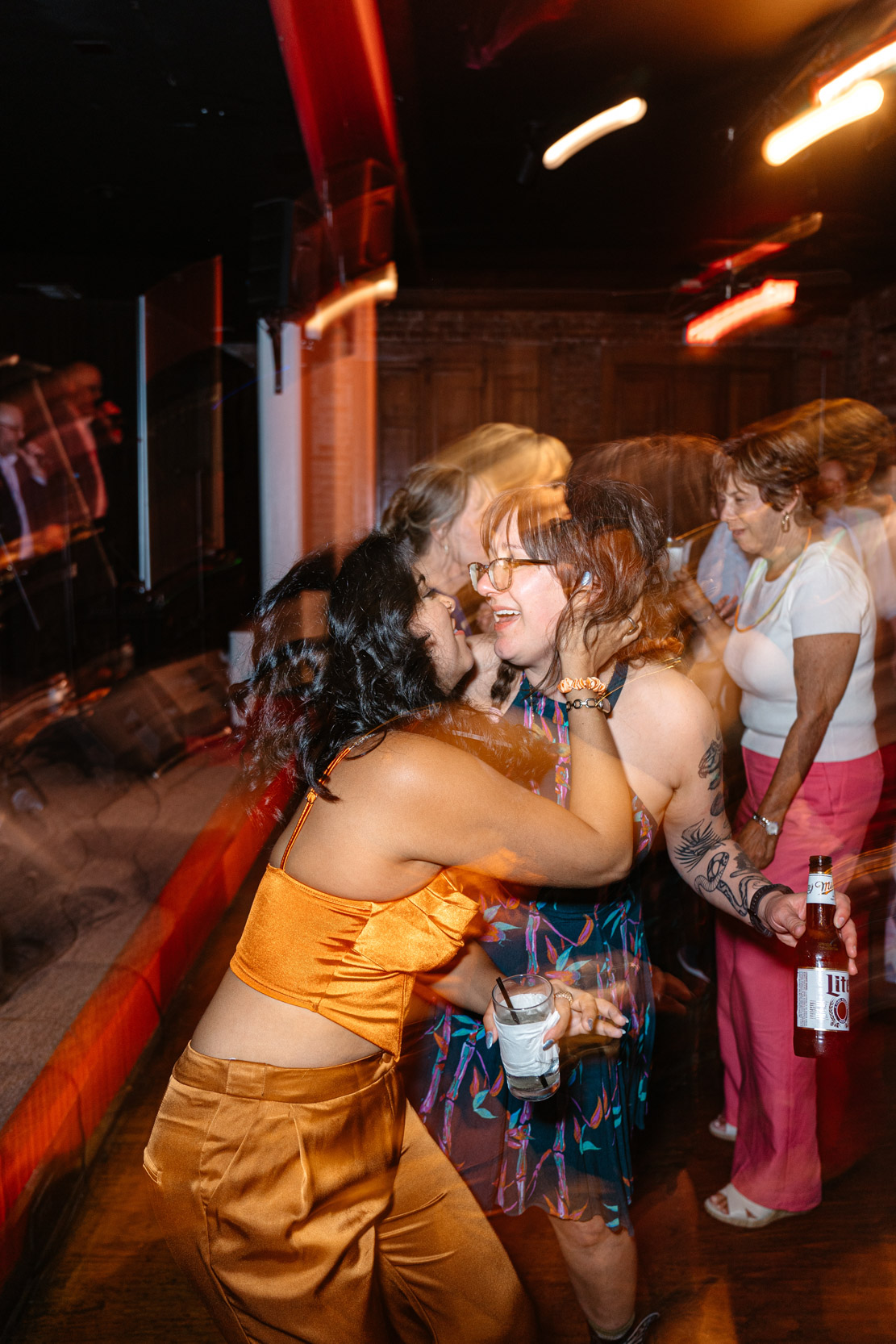 motion blur photo of wedding guests dancing during wedding reception at Rosy’s Jazz Hall in New Orleans