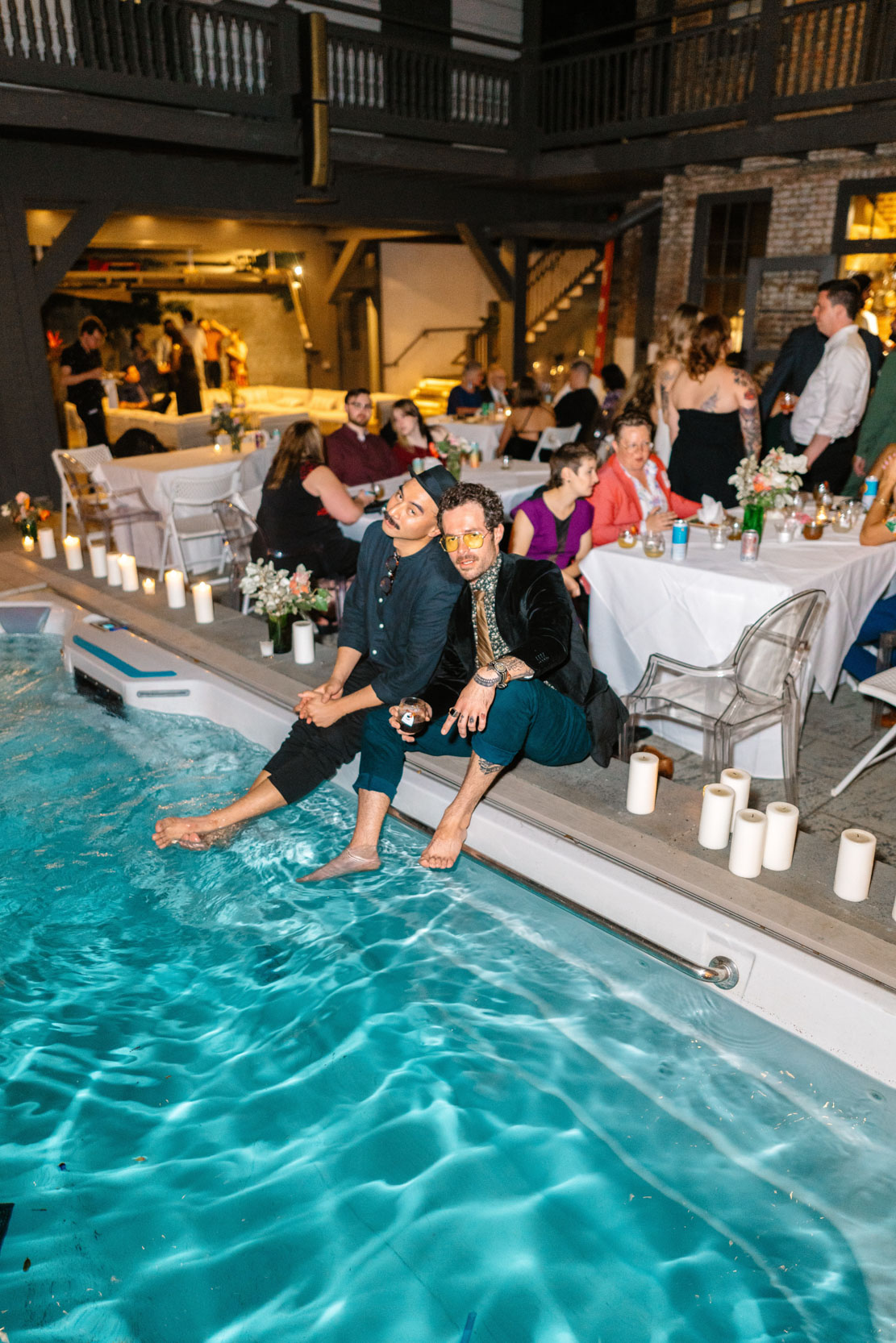 two men hanging out by pool at wedding reception at Margaret Place in New Orleans