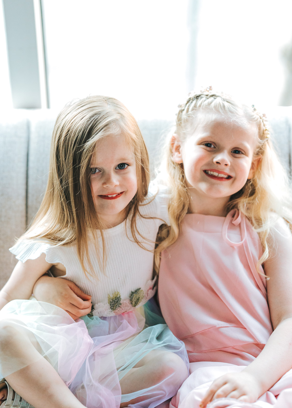 two small young girls smiling and wearing pastel dresses on wedding day at Capulet in the New Orleans Bywater