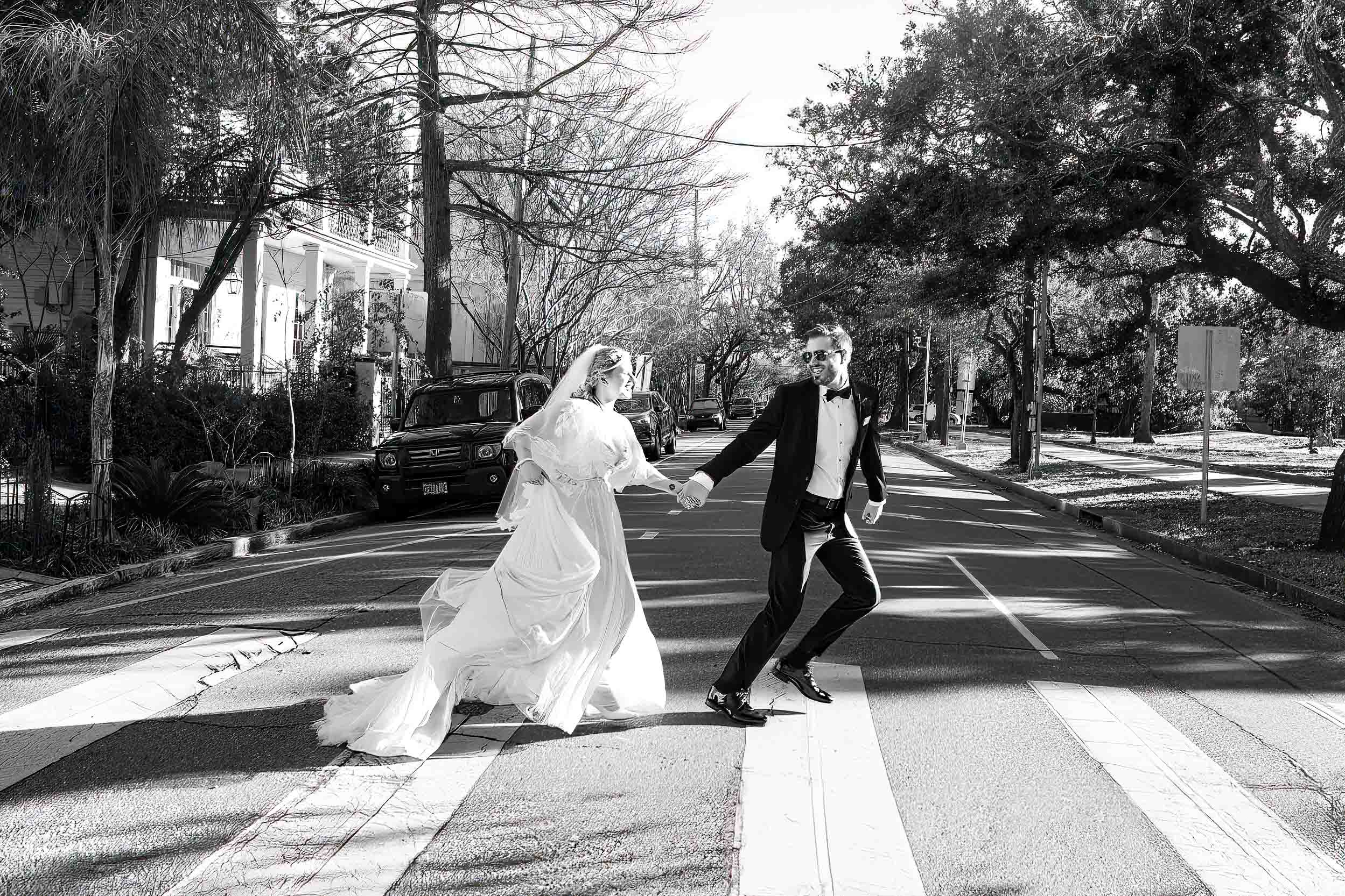bride and groom running across street in New Orleans on wedding day, inspired by The Beatles Abbey Road