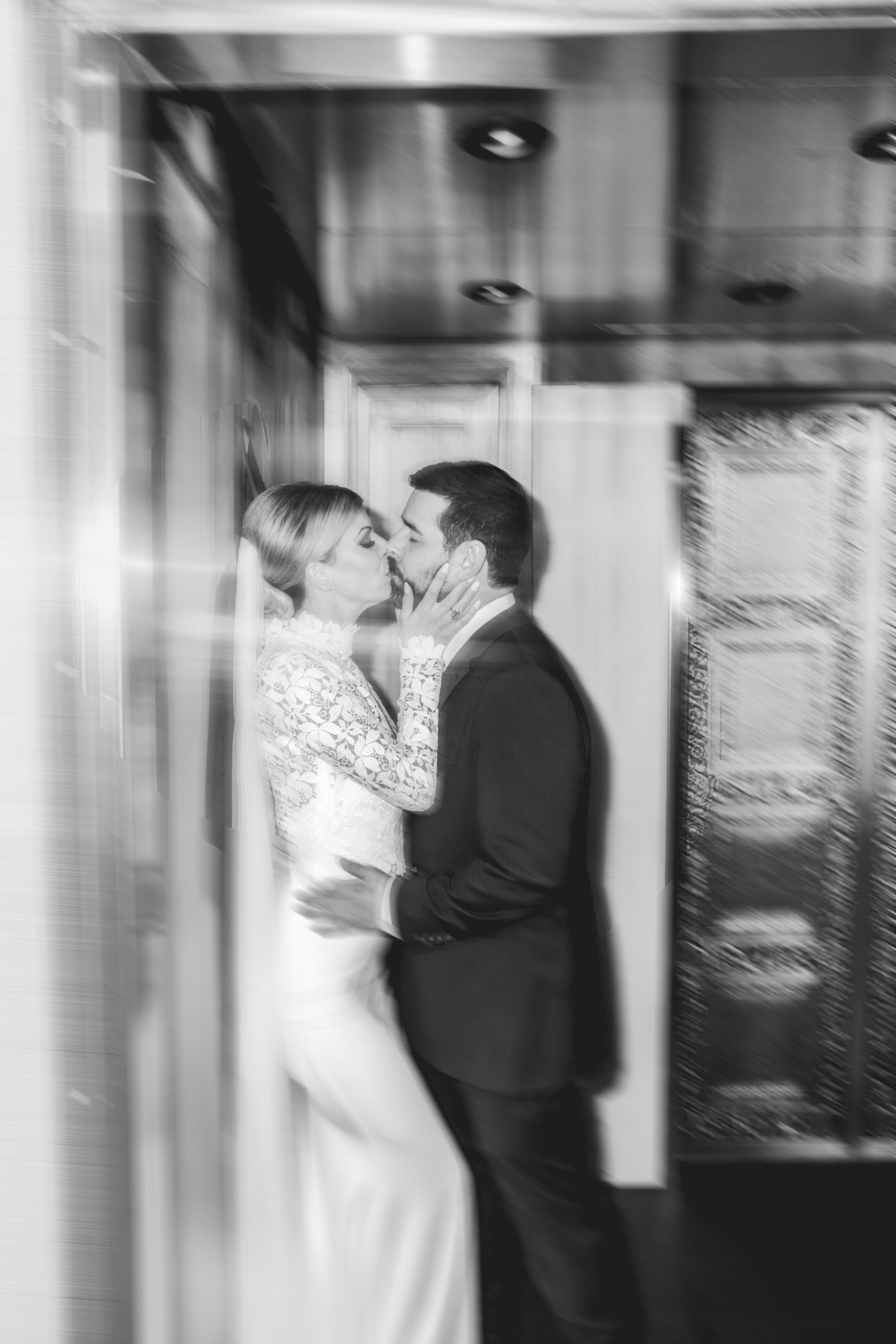 blurry flash photo of bride and groom kissing in elevator at the Southern Hotel in Covington, Louisiana