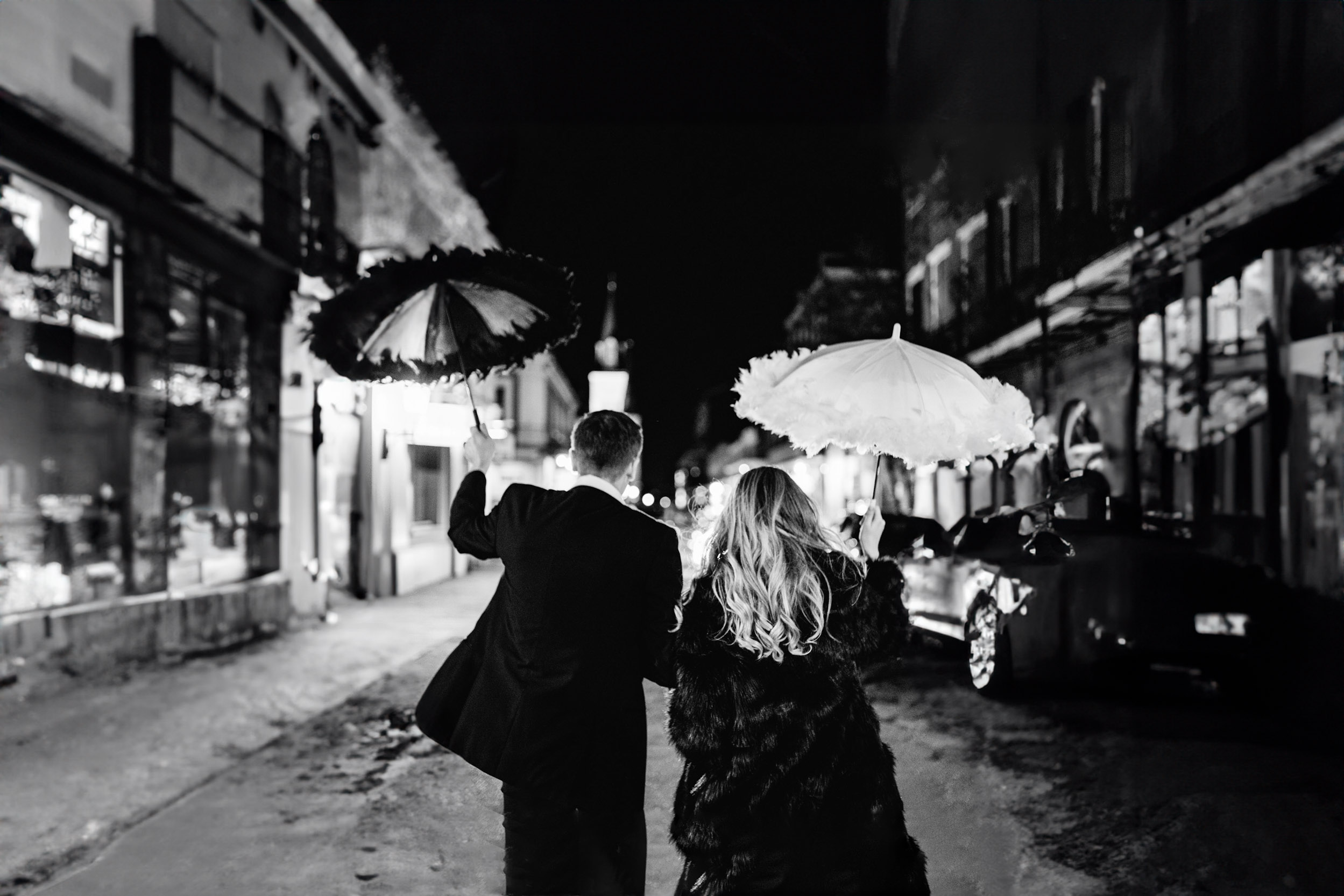 bride and groom celebrating with umbrellas on wedding day in the French Quarter of New Orleans